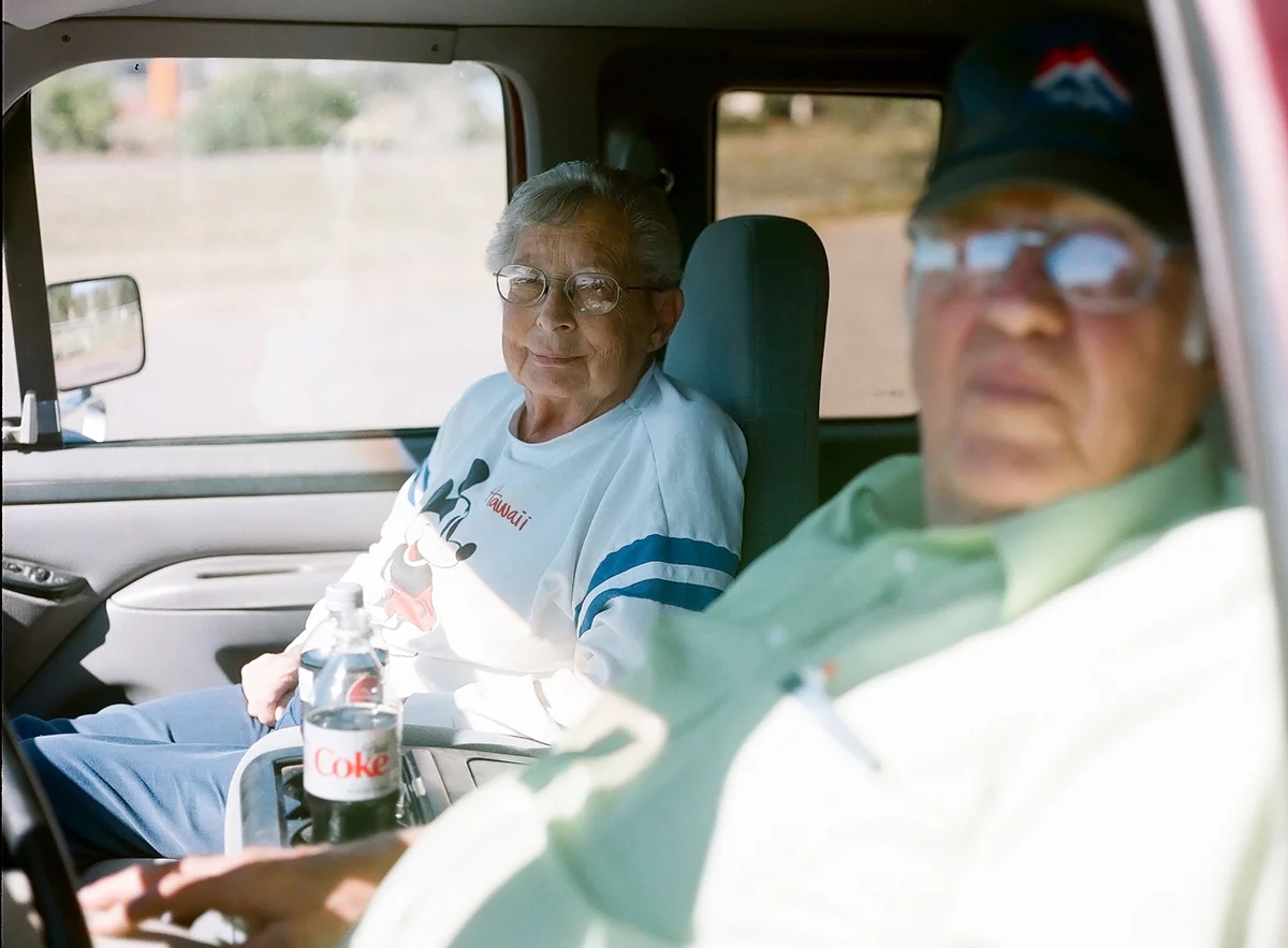 A couple sit in their car enjoying Diet Coke and a view after dumping yard waste outside of town. Escalante, population 793. October 2013.