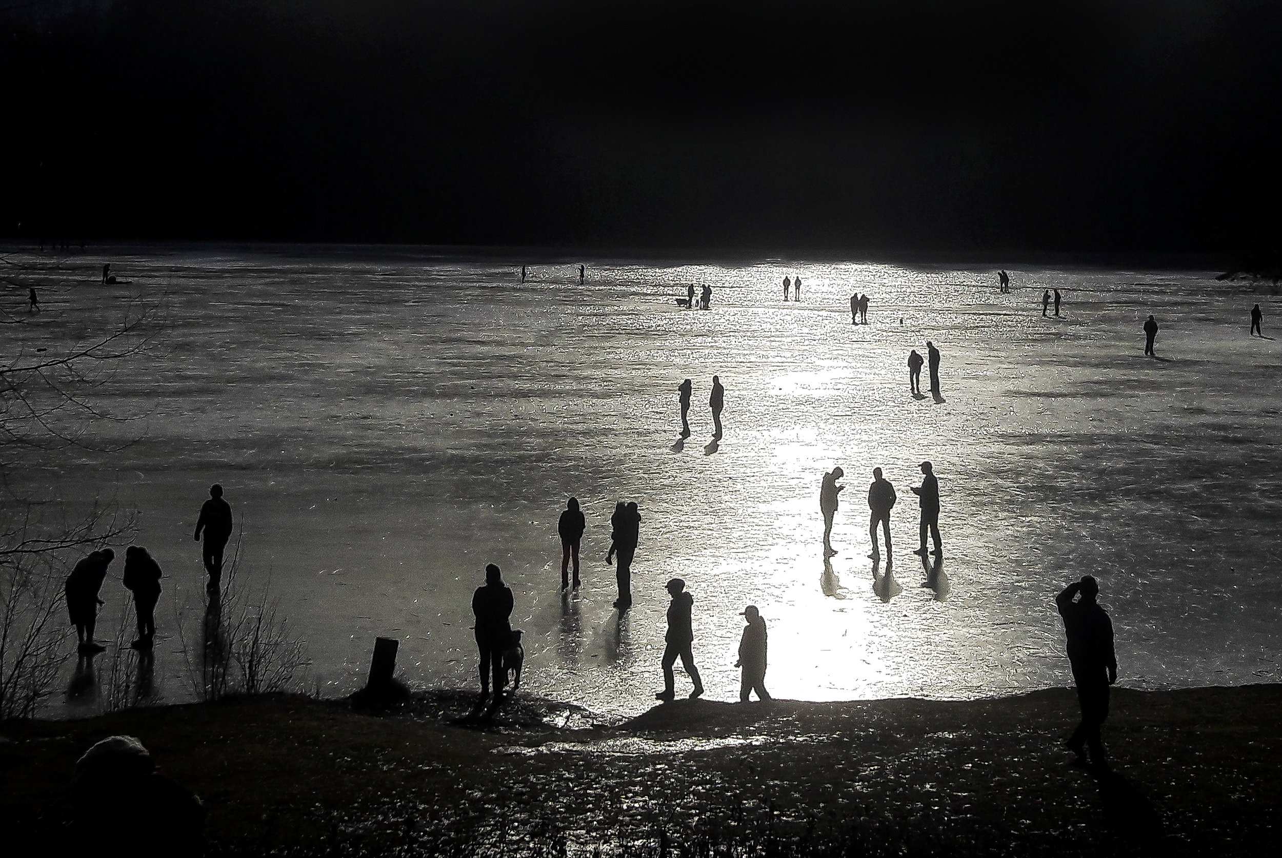  People walk, ice skate and play hockey on Lake Padden on Sunday, Jan. 15, in Bellingham. Signs posted around the lake warn that ice skating and other activities on the ice are hazardous. 
