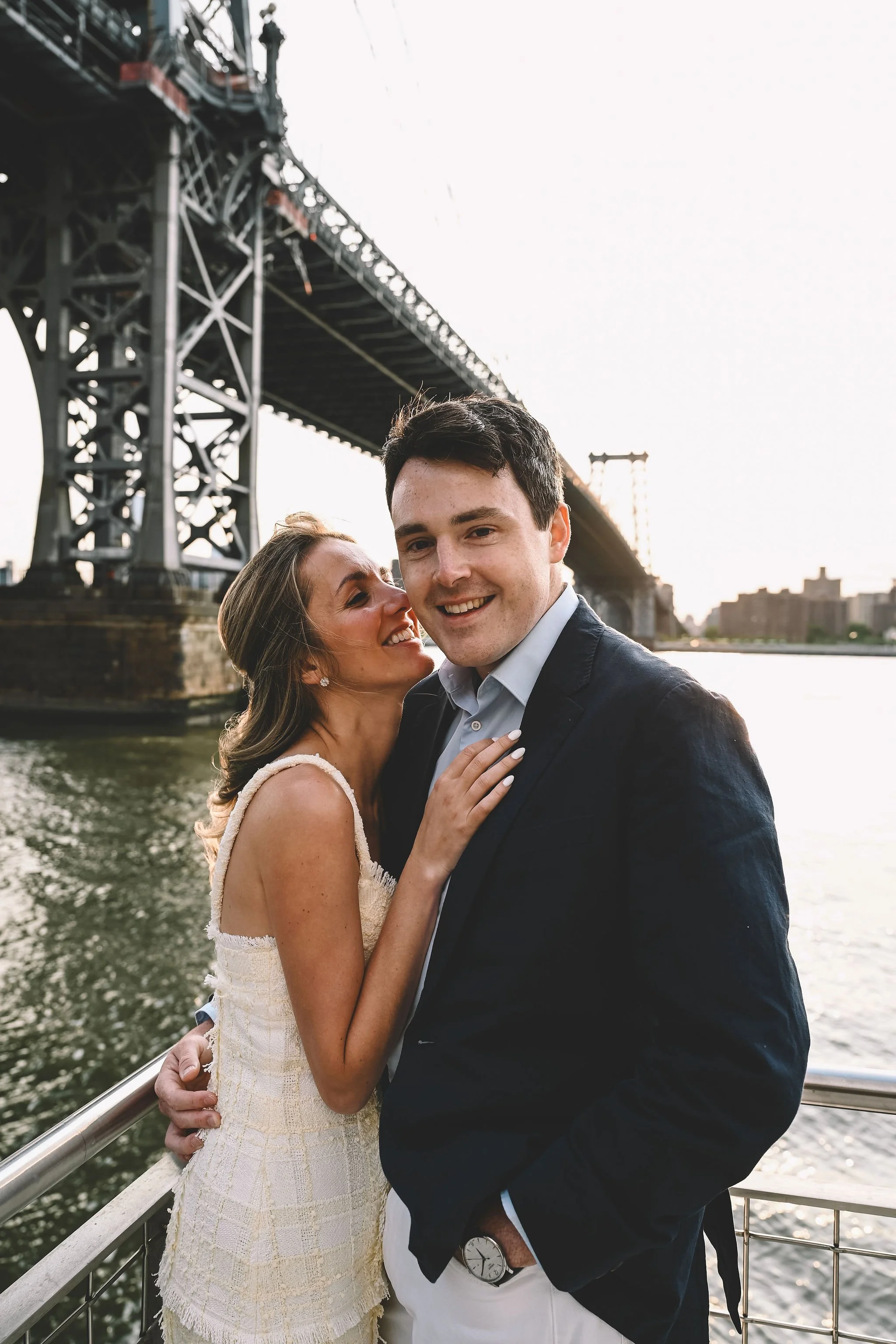 Williamsburg engagement session along the Brooklyn waterfront with the Manhattan Bridge in the background, captured in a refined, timeless style by NYC engagement photographer Robert Carlo.