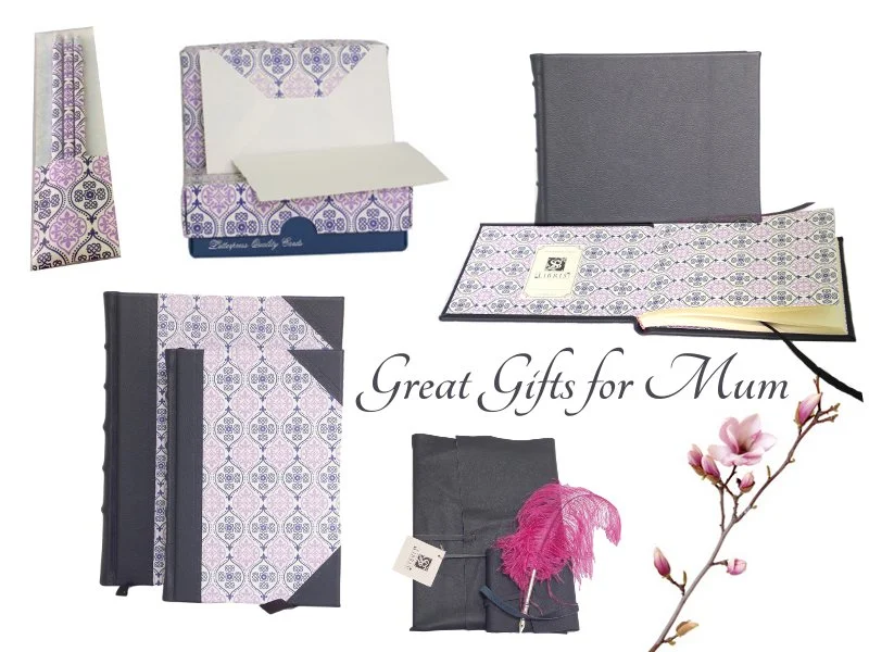 Clockwise from top left:  Letterpress pencil pack, Boxed Set of Correspondence Cards, Full Navy Leather Signature Book with Letterpress endpapers, Navy Wrap Journals (2 sizes), Pink Ostrich Feather Quill, Half Leather Journals in Letterpress design (2 sizes)