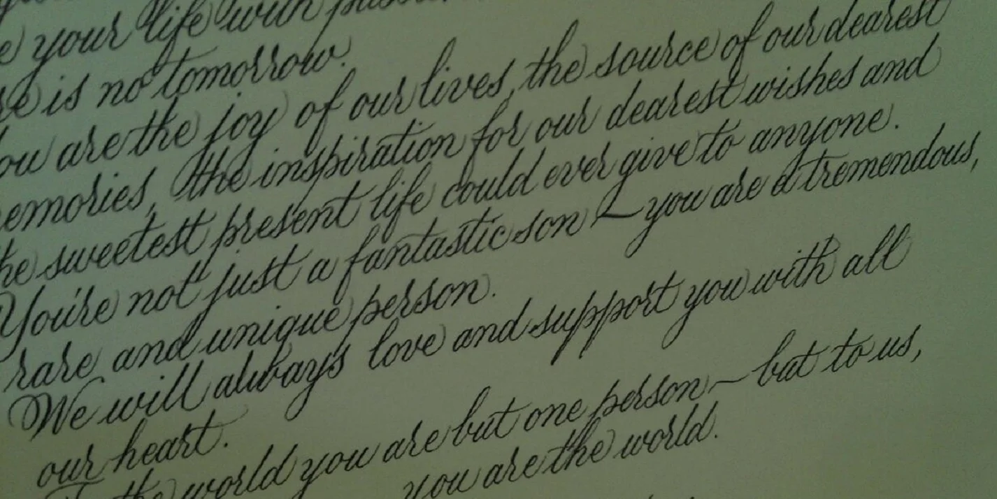 An example of a calligraphy tribute in the front cover of a custom binding. &nbsp;This example was actually a tribute written by parents to their son on his 21st birthday.