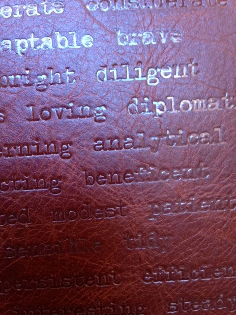 This custom binding featured a list of descriptive words embossed over the entire front of the full leather binding