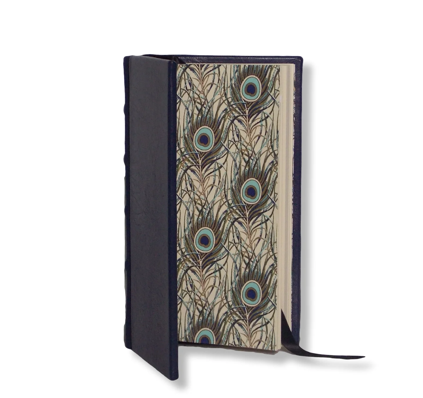 SLIMLINE LEATHER JOURNAL IN NAVY   A full navy leather bound cover with gold foiled peacock design end papers.&nbsp;  70 cream pages.&nbsp;  Classic raised bands on the spine.  Product dimensions: 17.5cm x 9.5cm  Perfect for&nbsp;personalisation&nbsp;with a name, date, initials or&nbsp;quotes