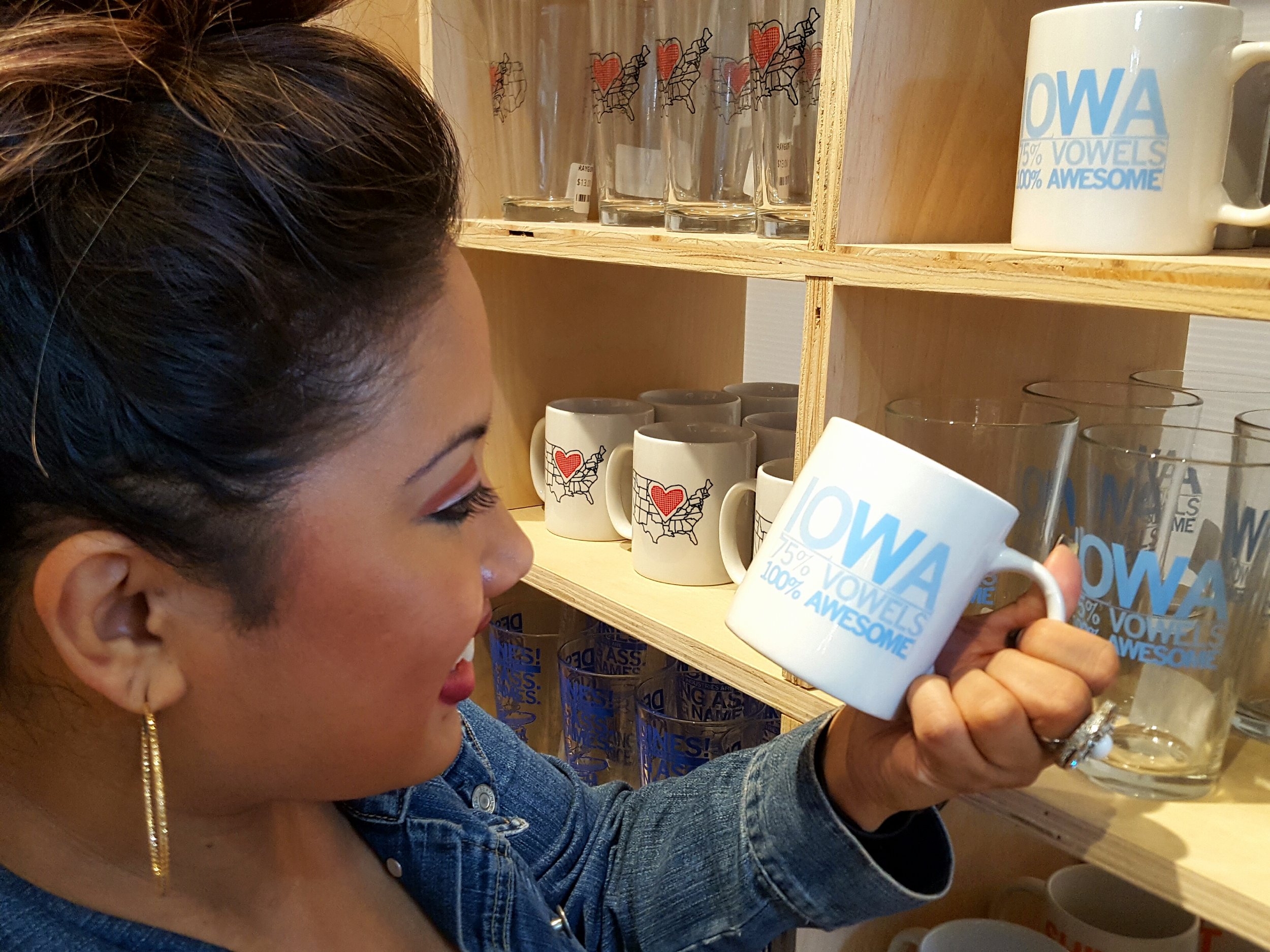 Shopper Lyra Bristow chuckles at just the perfect coffee mug. "Iowa: 75% Vowels, 100% Awesome"