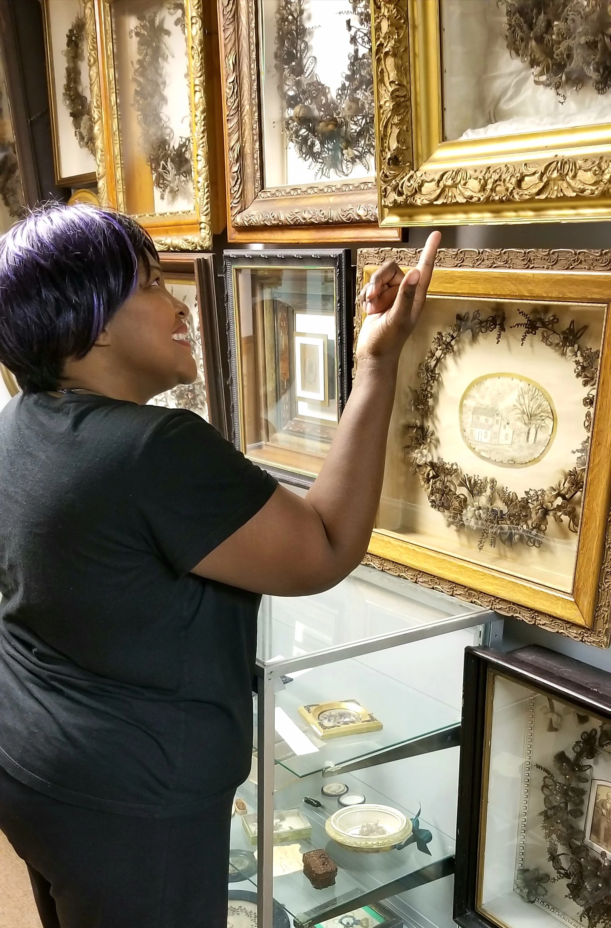 Visitor Sonya Edmon Larson takes a gander at some of the intricate wreaths at the museum.