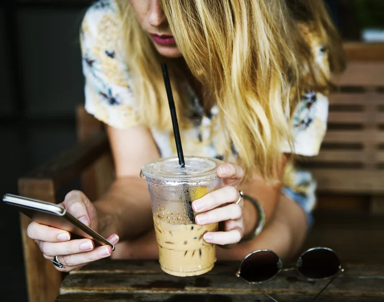 Woman drink and phone.jpg