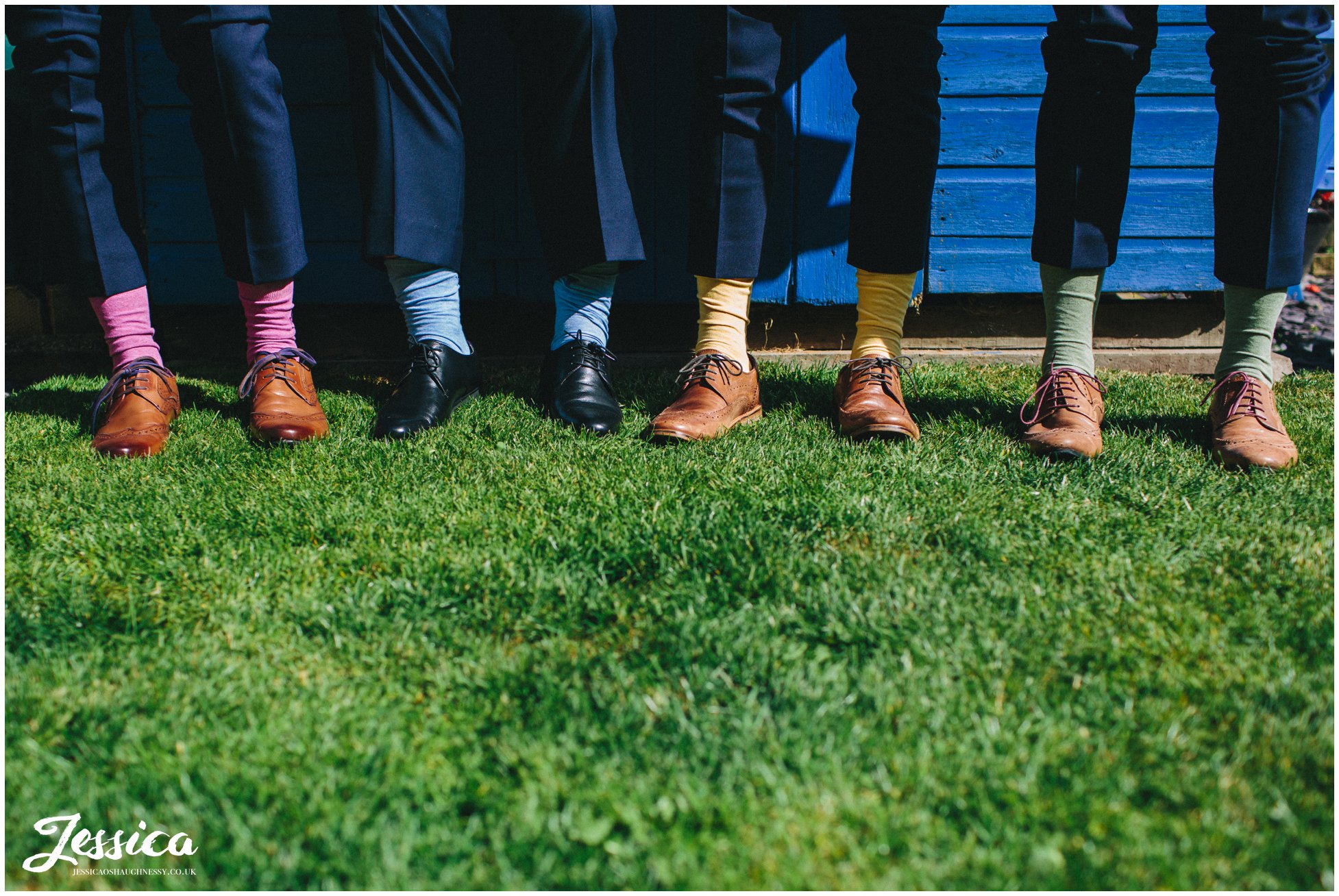 close up of groomsmens feet wearing multi coloured socks - wedding photographer