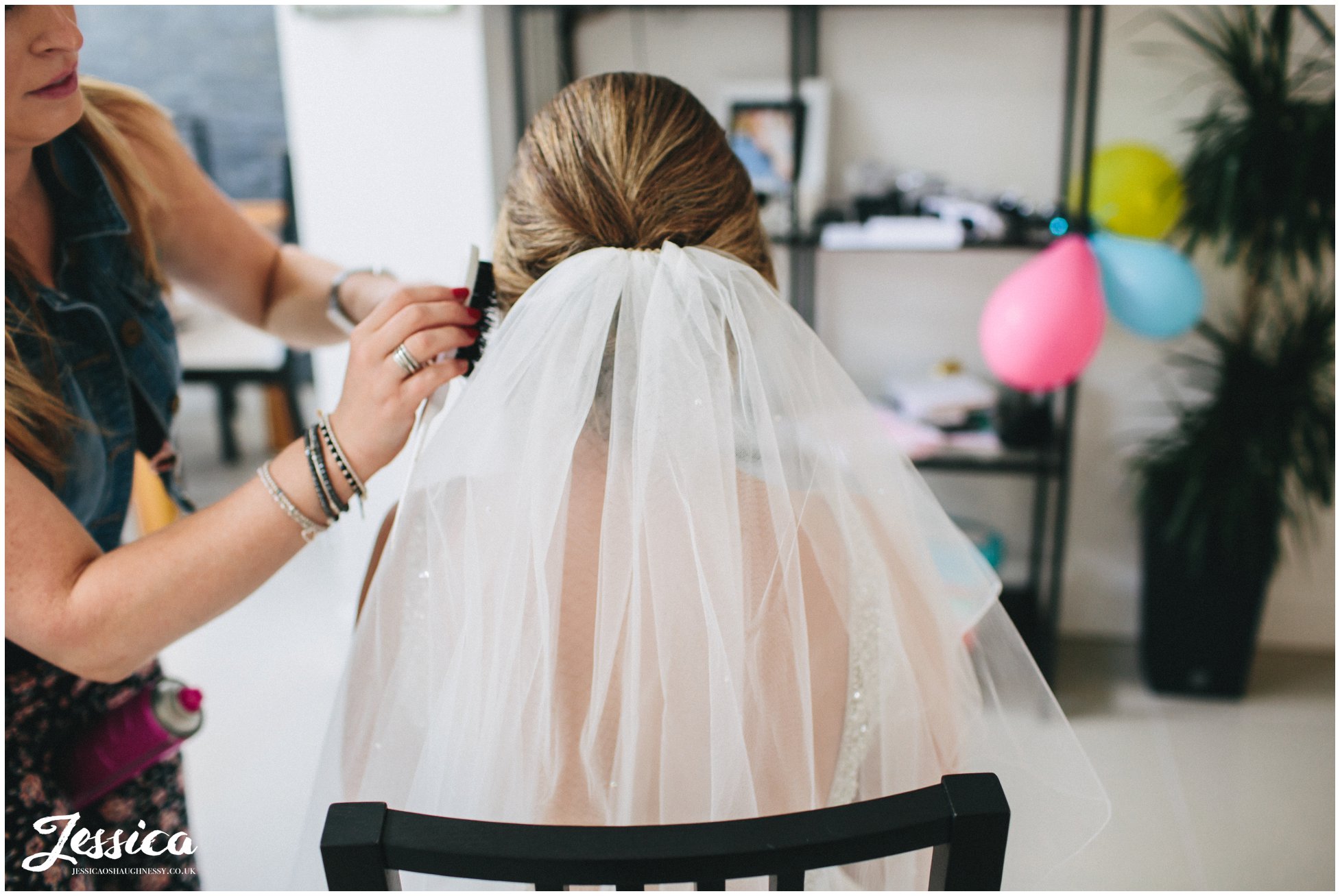 bride has her veil fitted on the morning of her wedding day