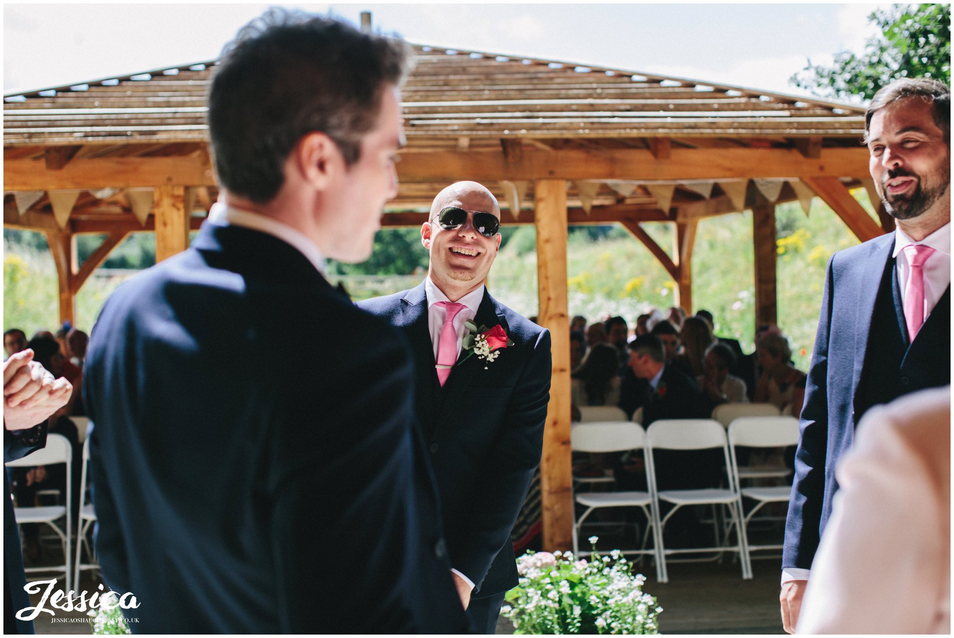 the groom laughs as he waits for his bride to arrive - tower hill barns wedding photography