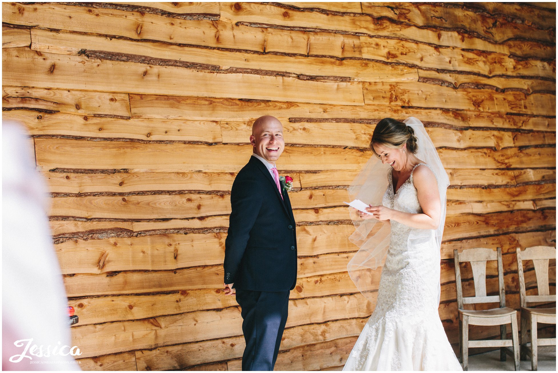 bride & groom laugh whilst they exchange their vows at tower hill barns