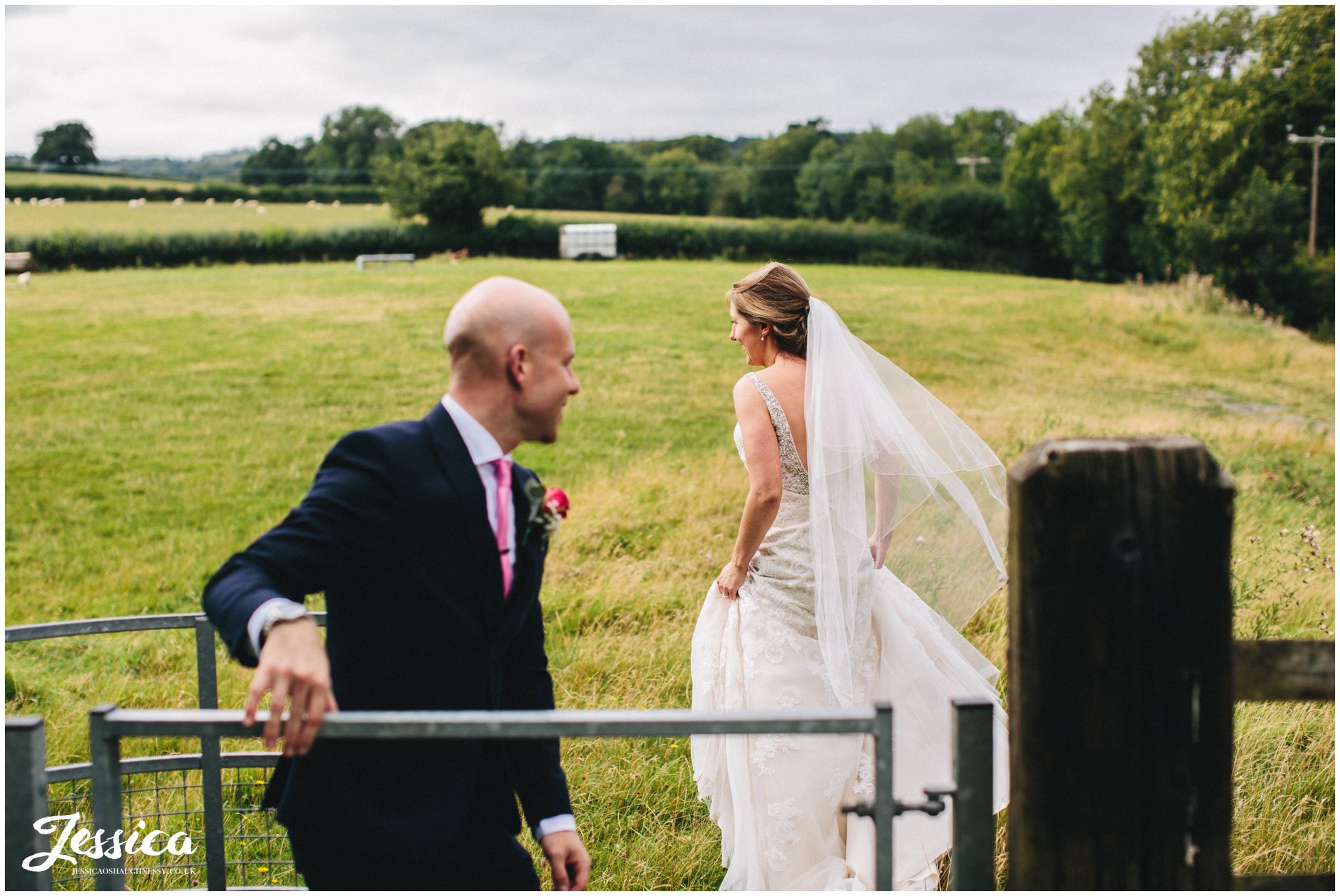 the bride & groom go wandering through the fields in north wales