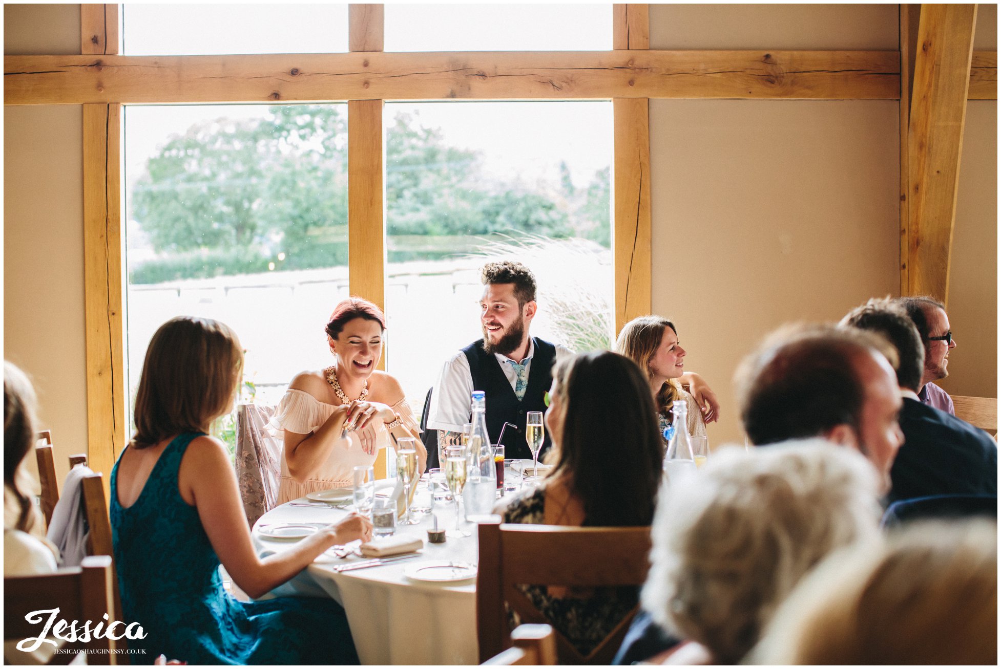 guests laughing during the speeches at tower hill barns in north wales