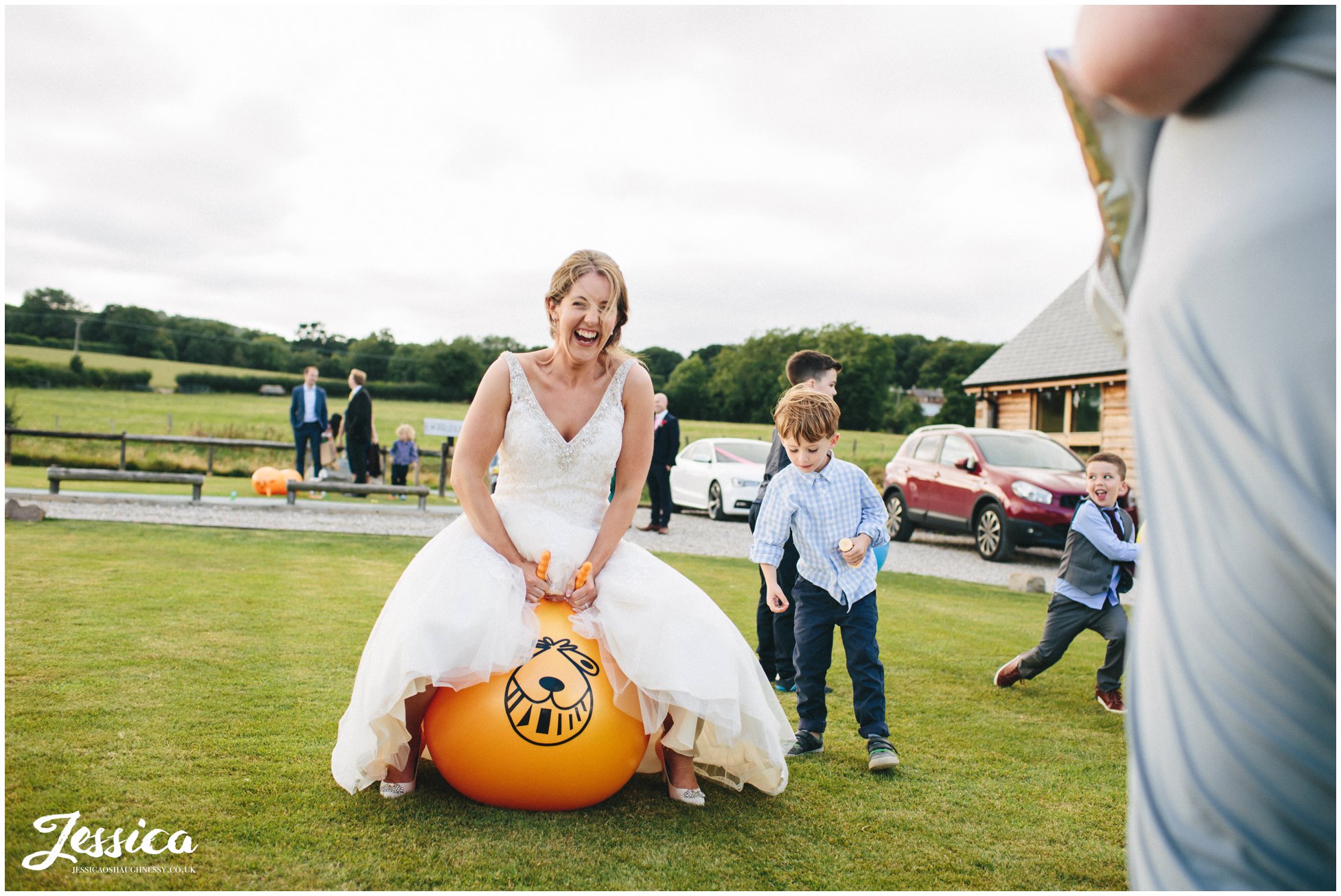 tower hill barns wedding - bride bouncing on space hopper 