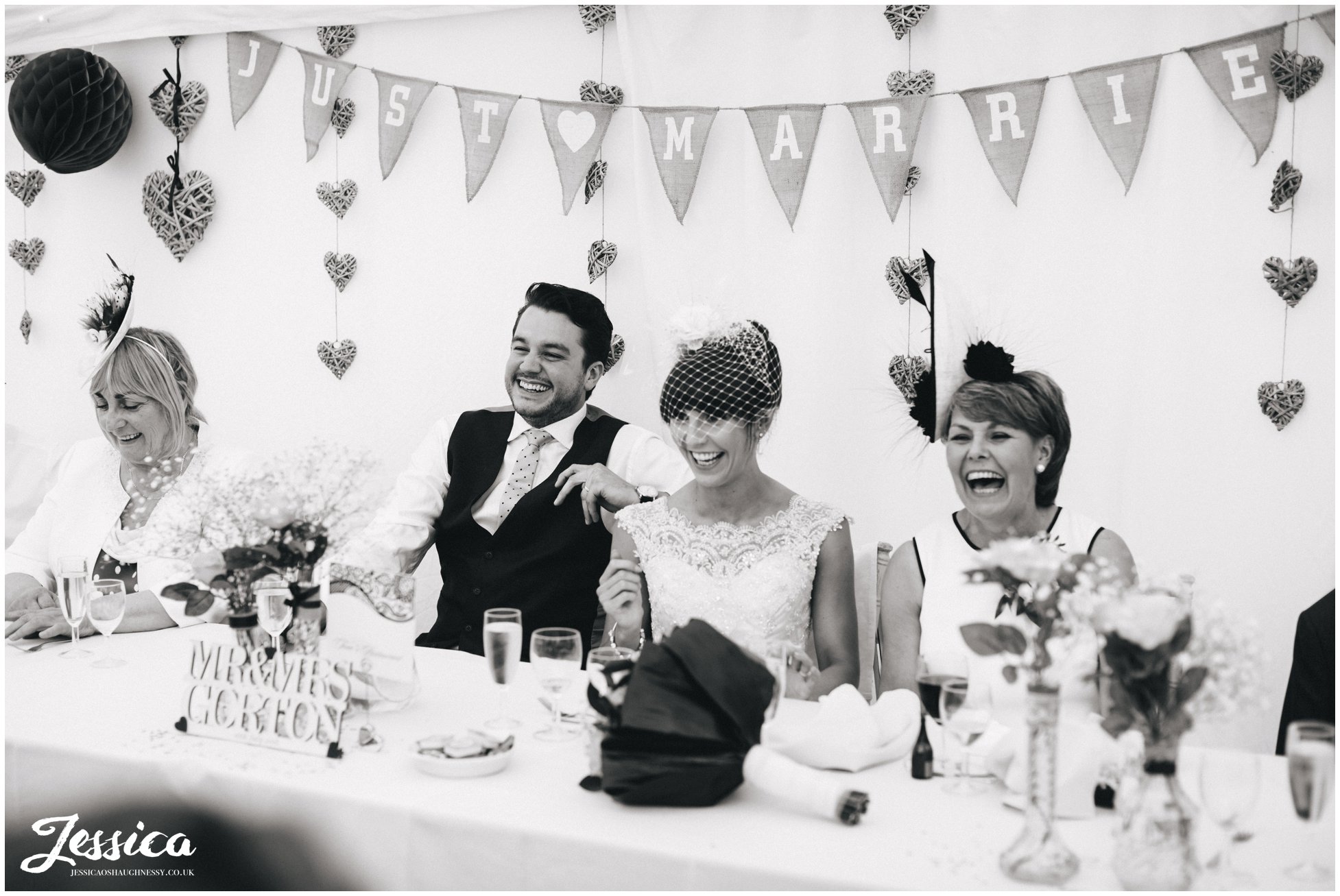 top table laugh during the speeches at a wedding in trafford hall - chester wedding photographer