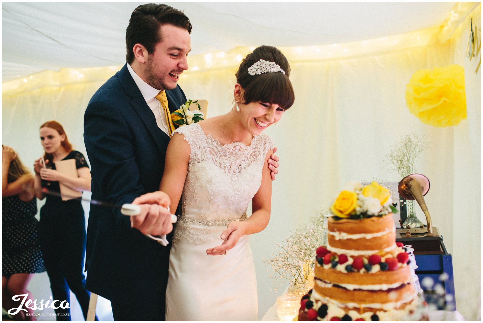 newly wed's cut the cake on their wedding day in chester