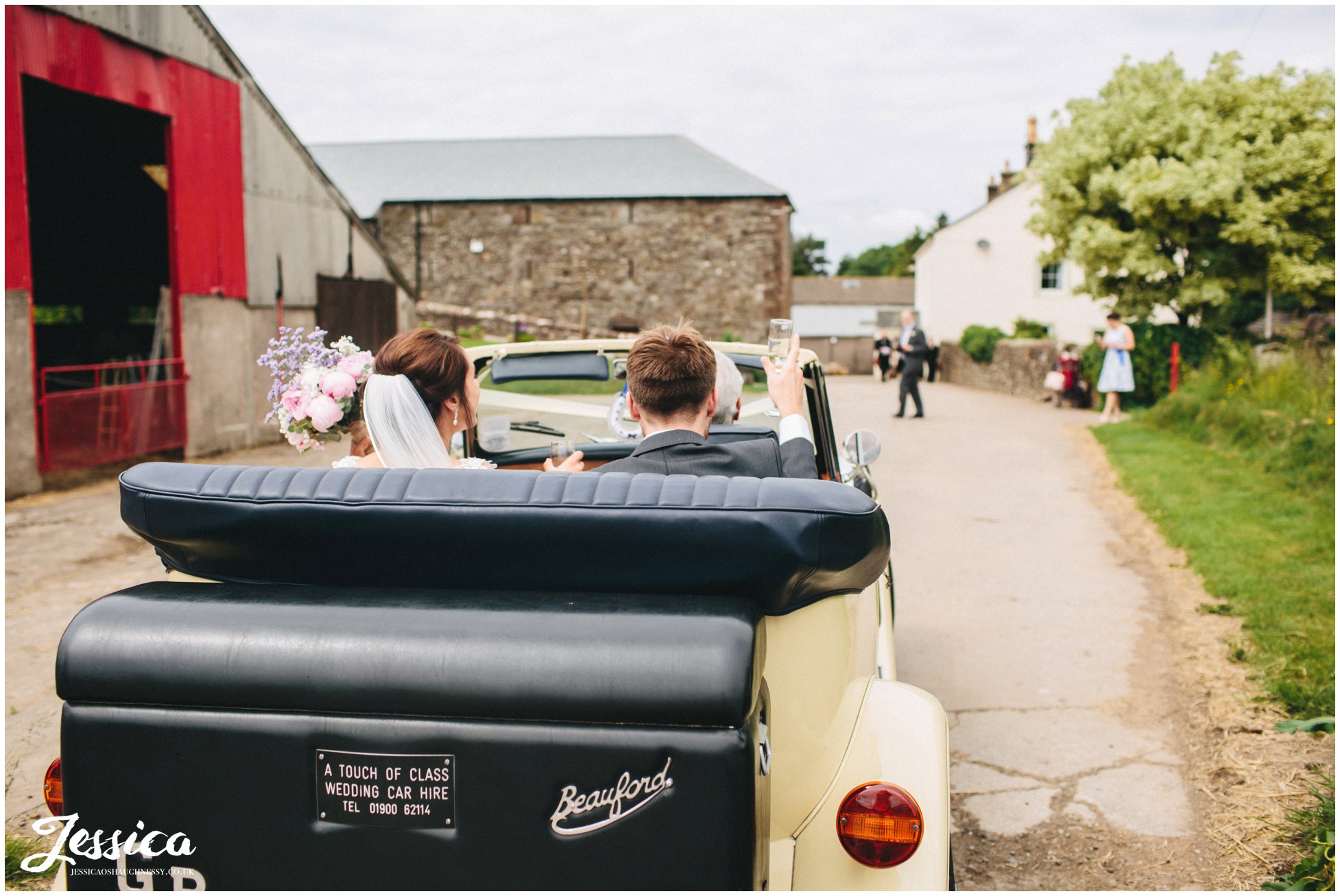 bride & groom arrive in car at three hills barn in torpenhow, cumbria wedding photographer