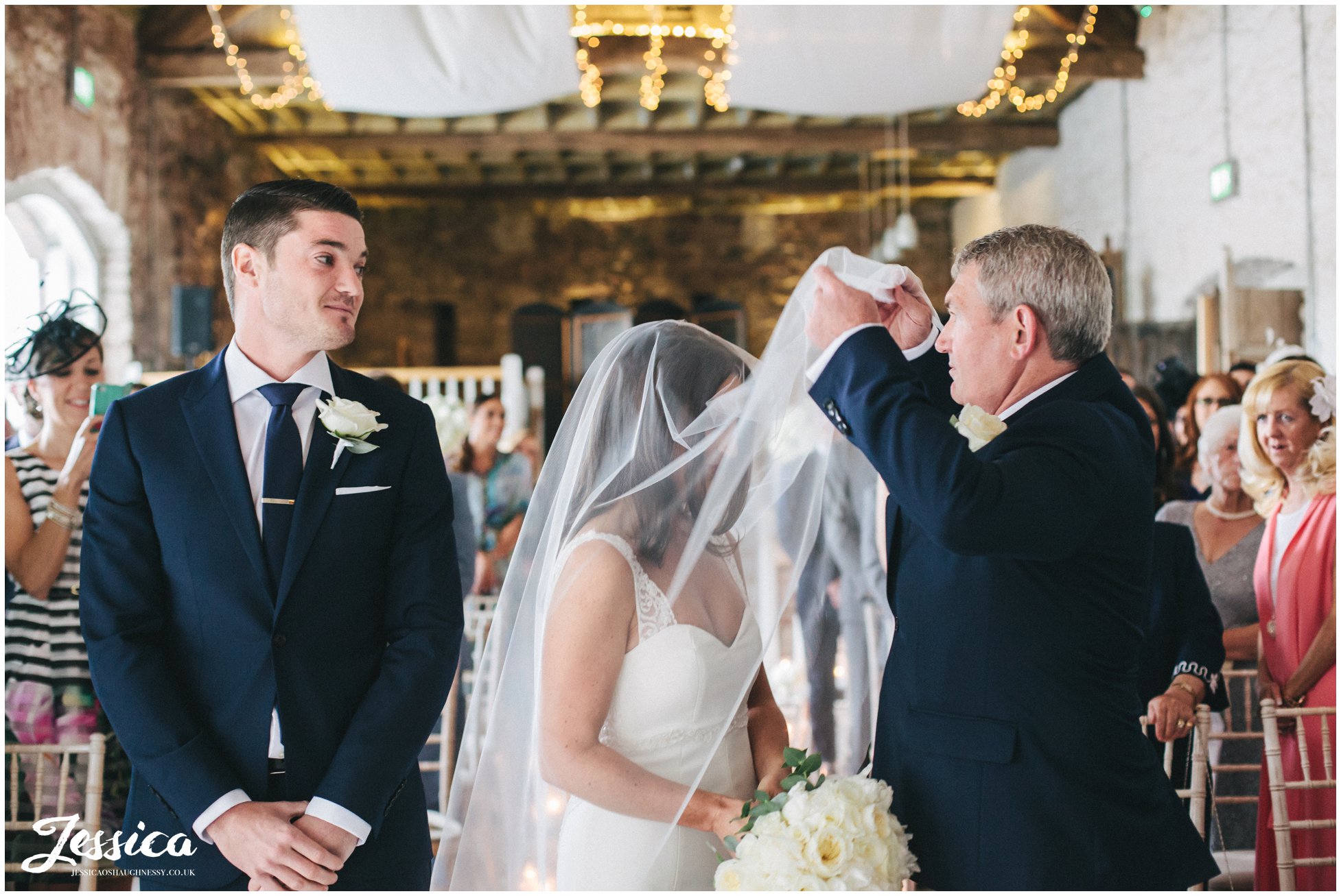 father of the bride lifts brides veil at her askham hall wedding