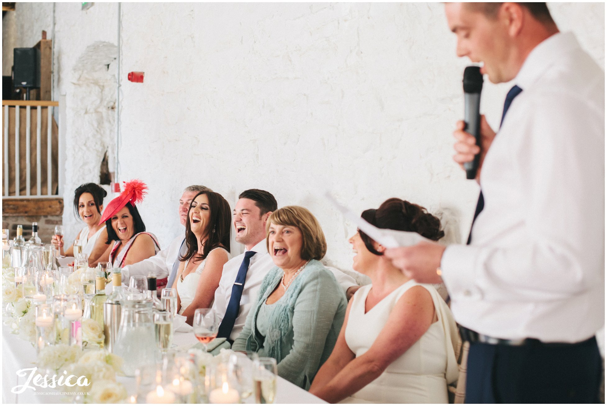 top table laugh at best man's speech at a lake district wedding, penrith