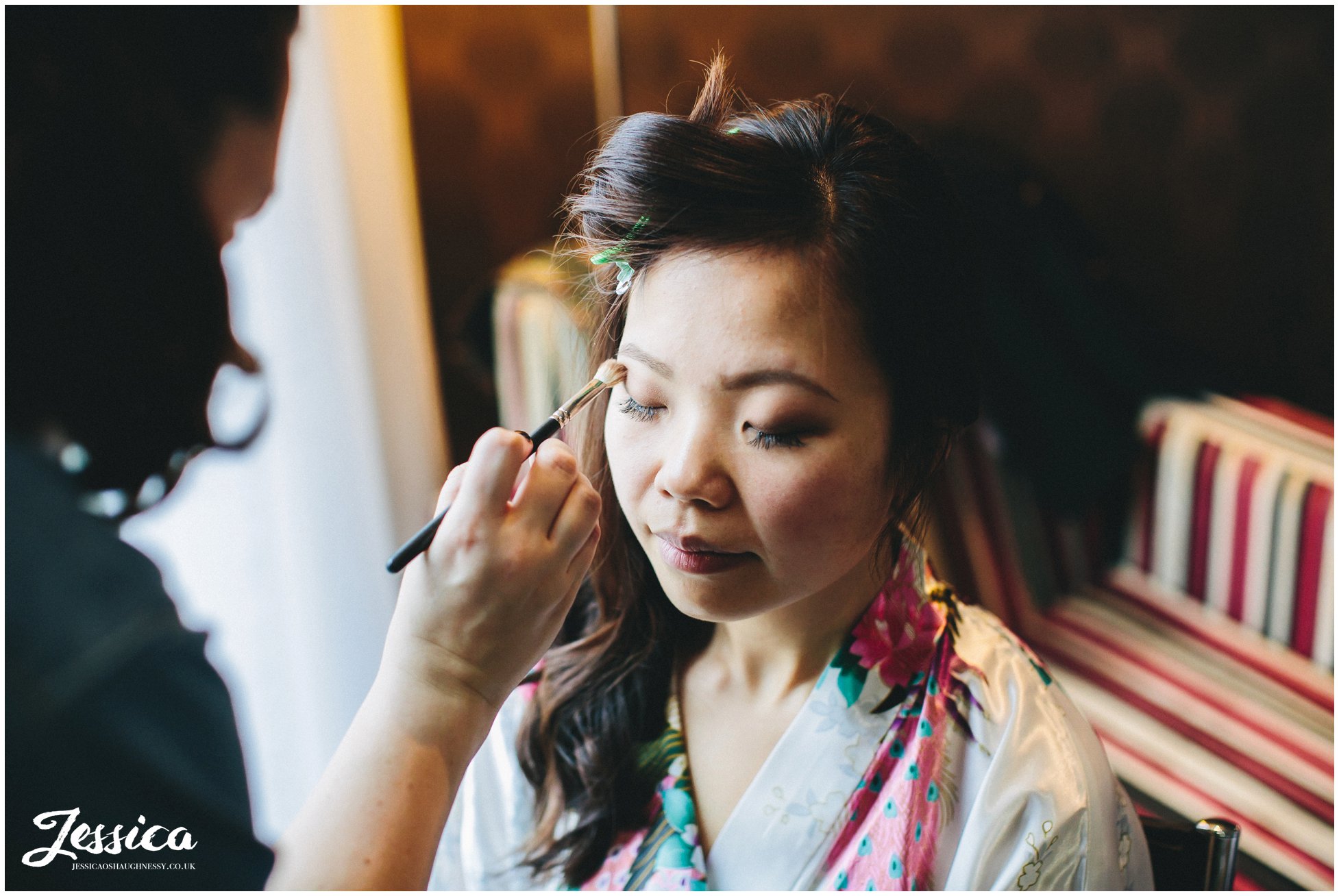 zoe has her makeup done on her wedding morning in media city, manchester