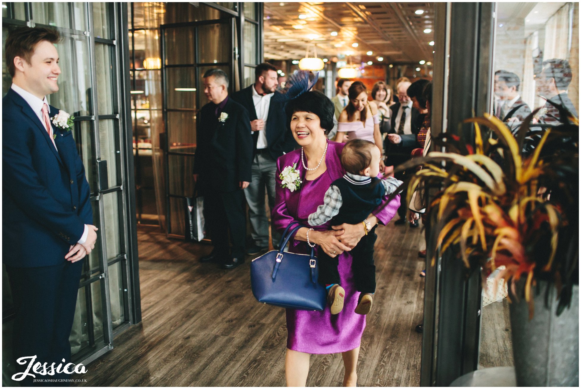 mother of the bride enters ceremony room to wait for her daughters entrance - on the 7th wedding