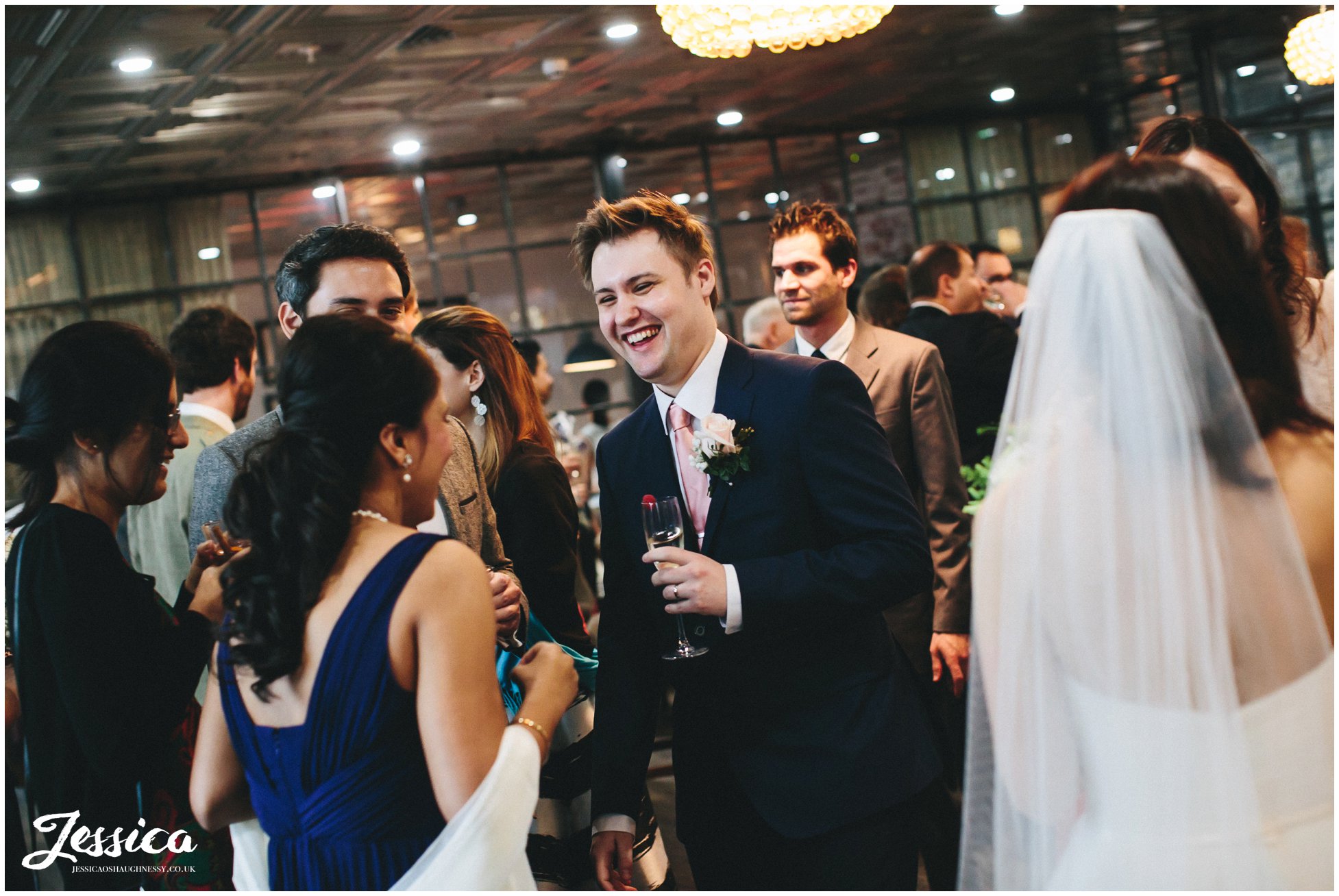 groom laughs with guests after his wedding ceremony in manchester