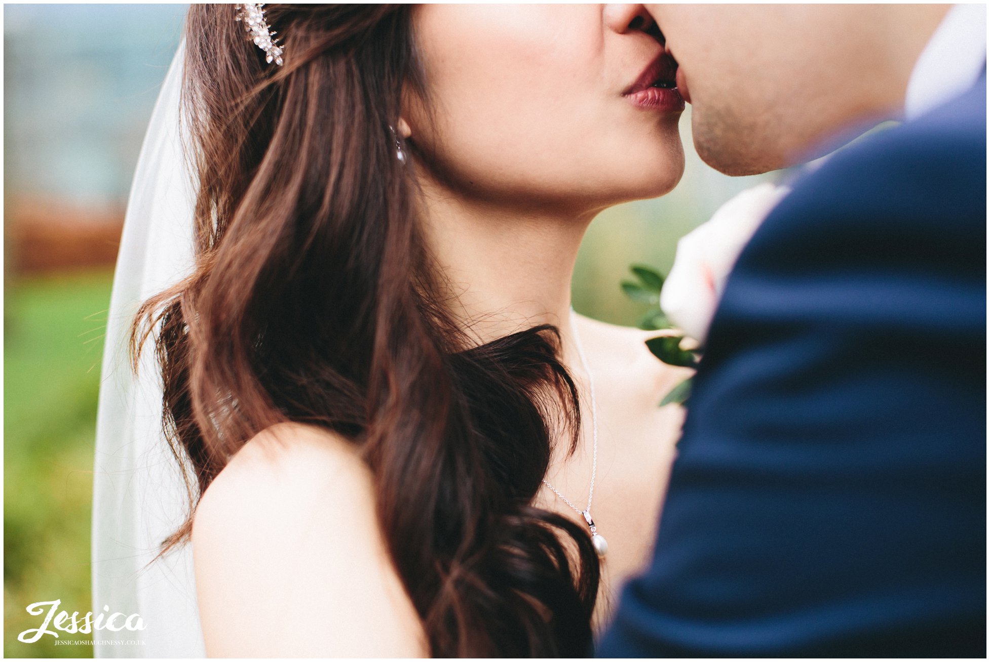 close up of the bride & groom kissing in Media City, Manchester