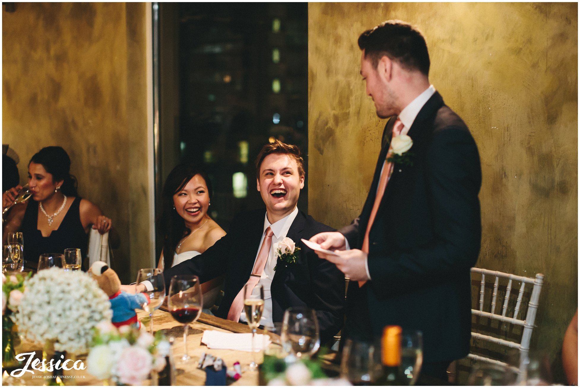 couple laugh during the best mans speech - salford wedding photography