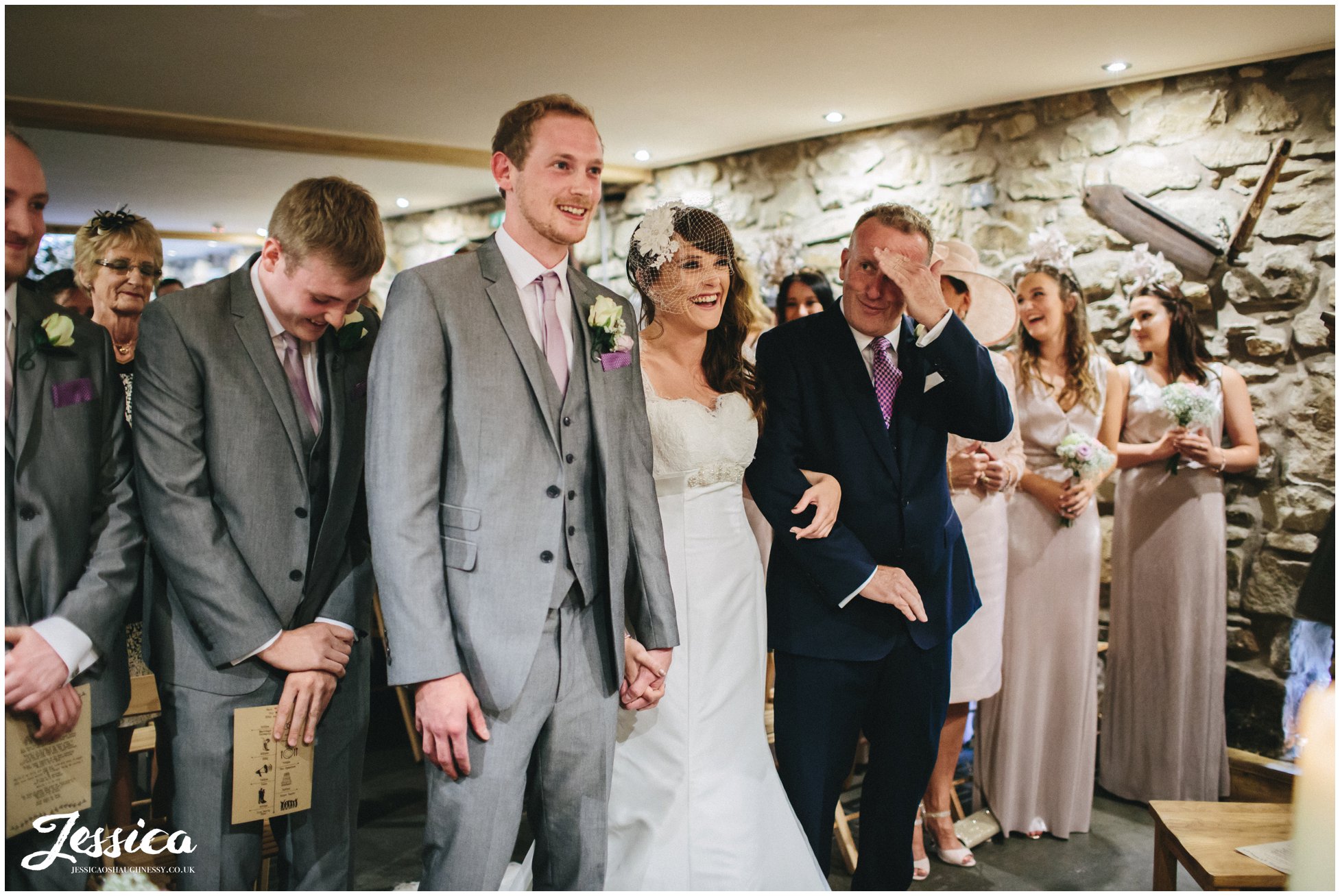 bride & groom laugh during their north wales wedding ceremony