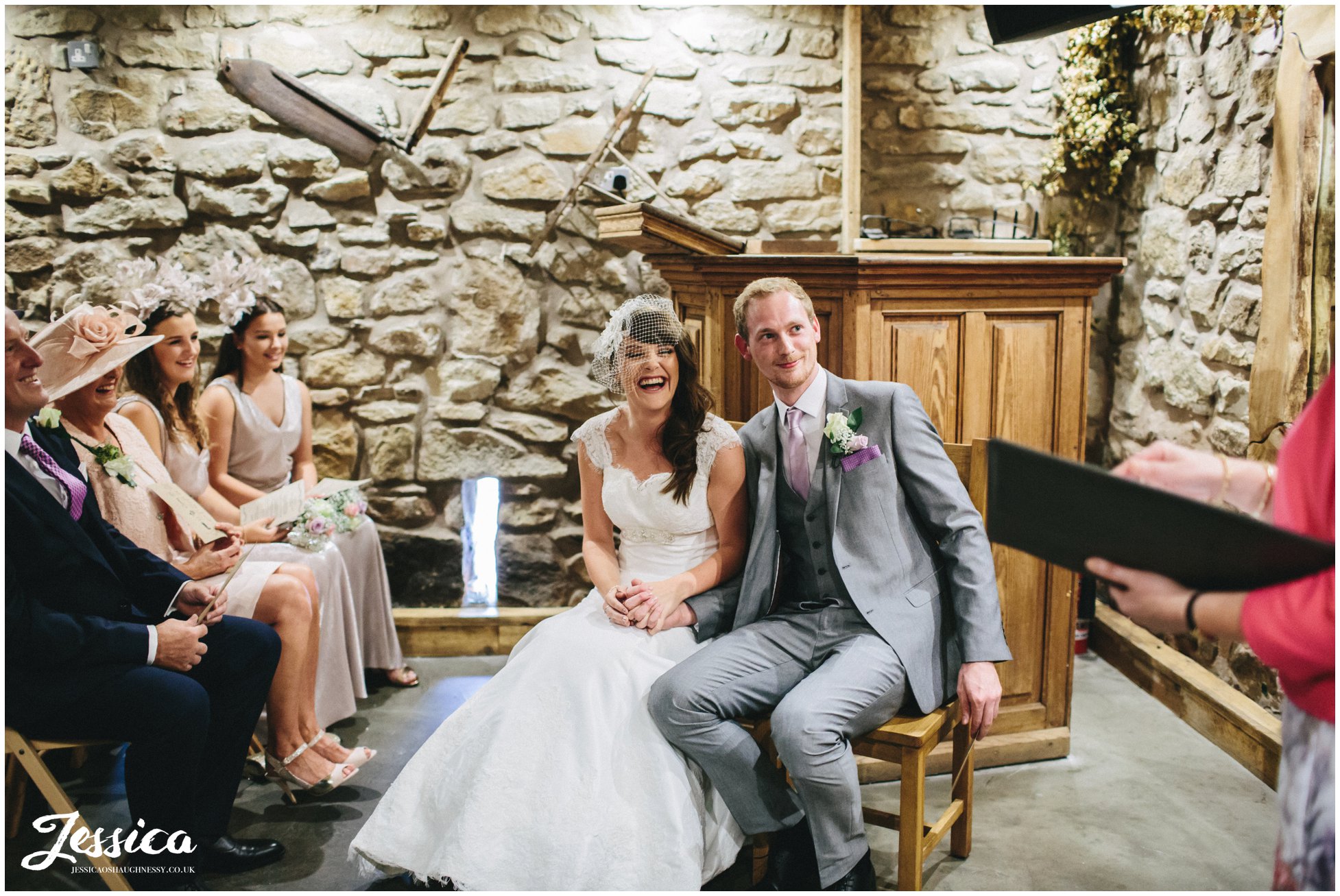 couple sit during their wedding ceremony at tower hill barns