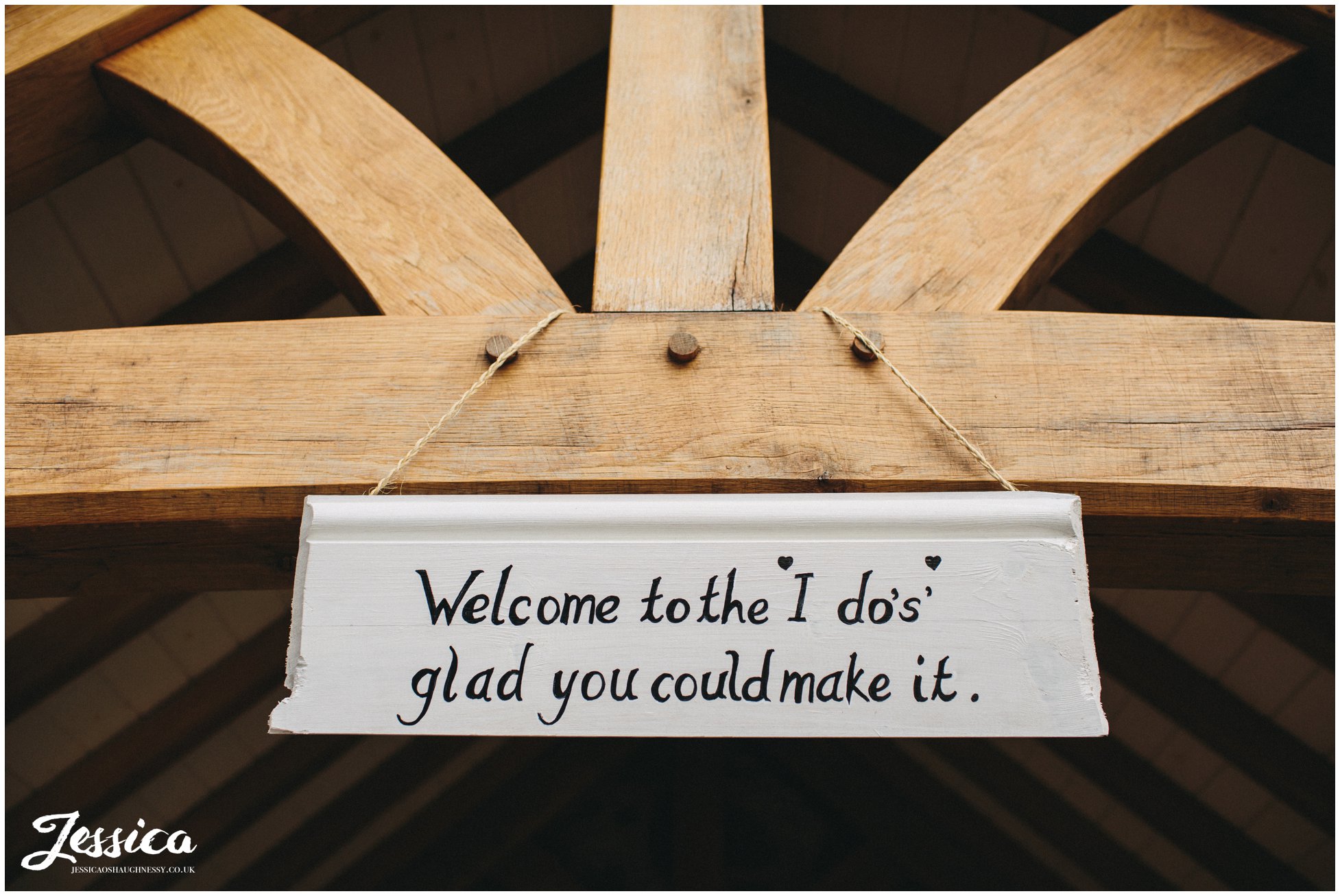 sign at the entrance to tower hill barns wedding venue, welcoming guests into the ceremony