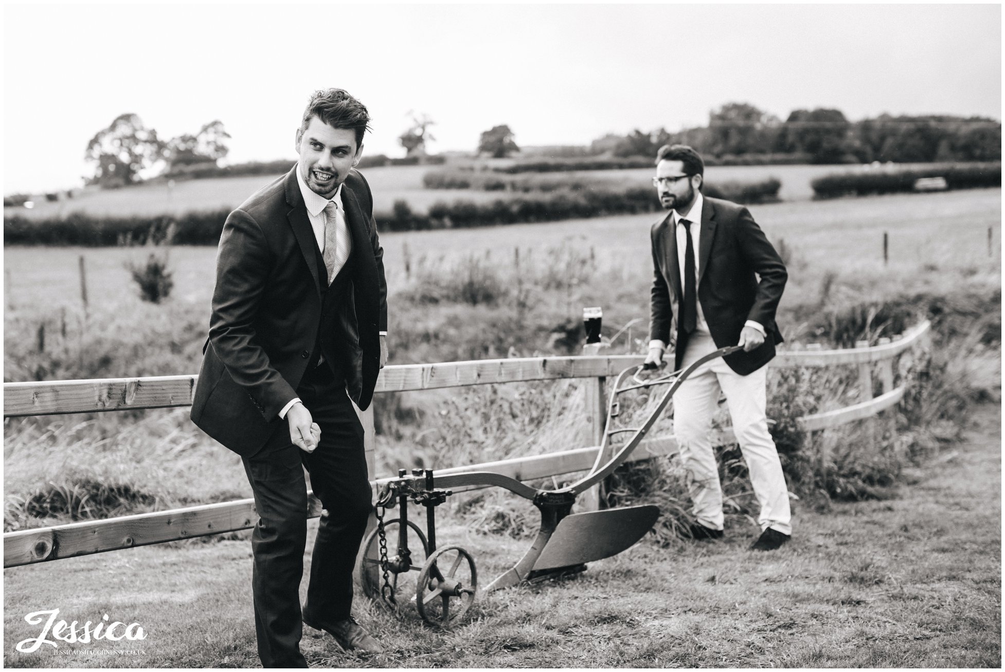 guests joke with farming equipment at tower hill barns wedding venue 