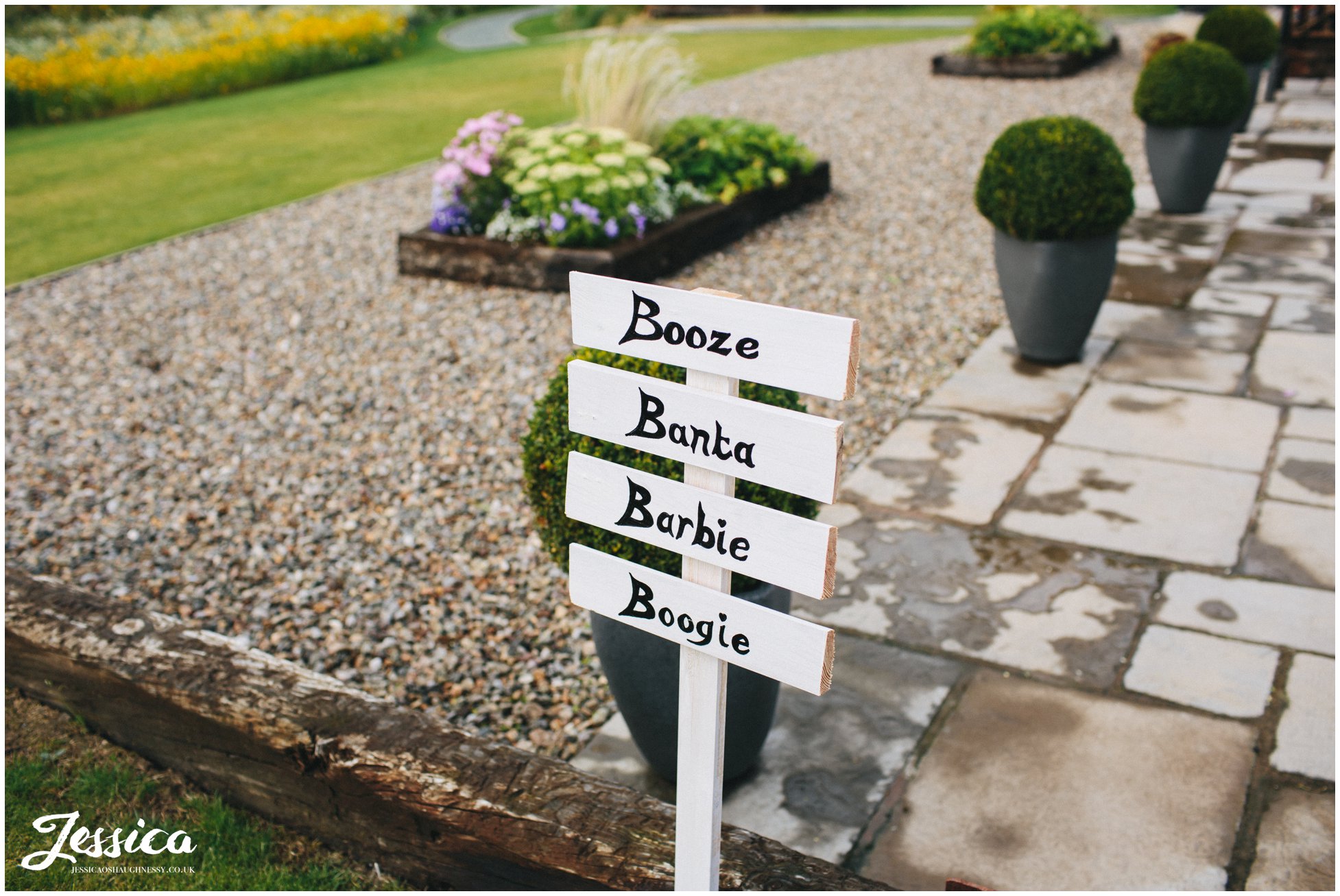 sign saying booze, banta, barbie & boogie at a tower hill barns wedding