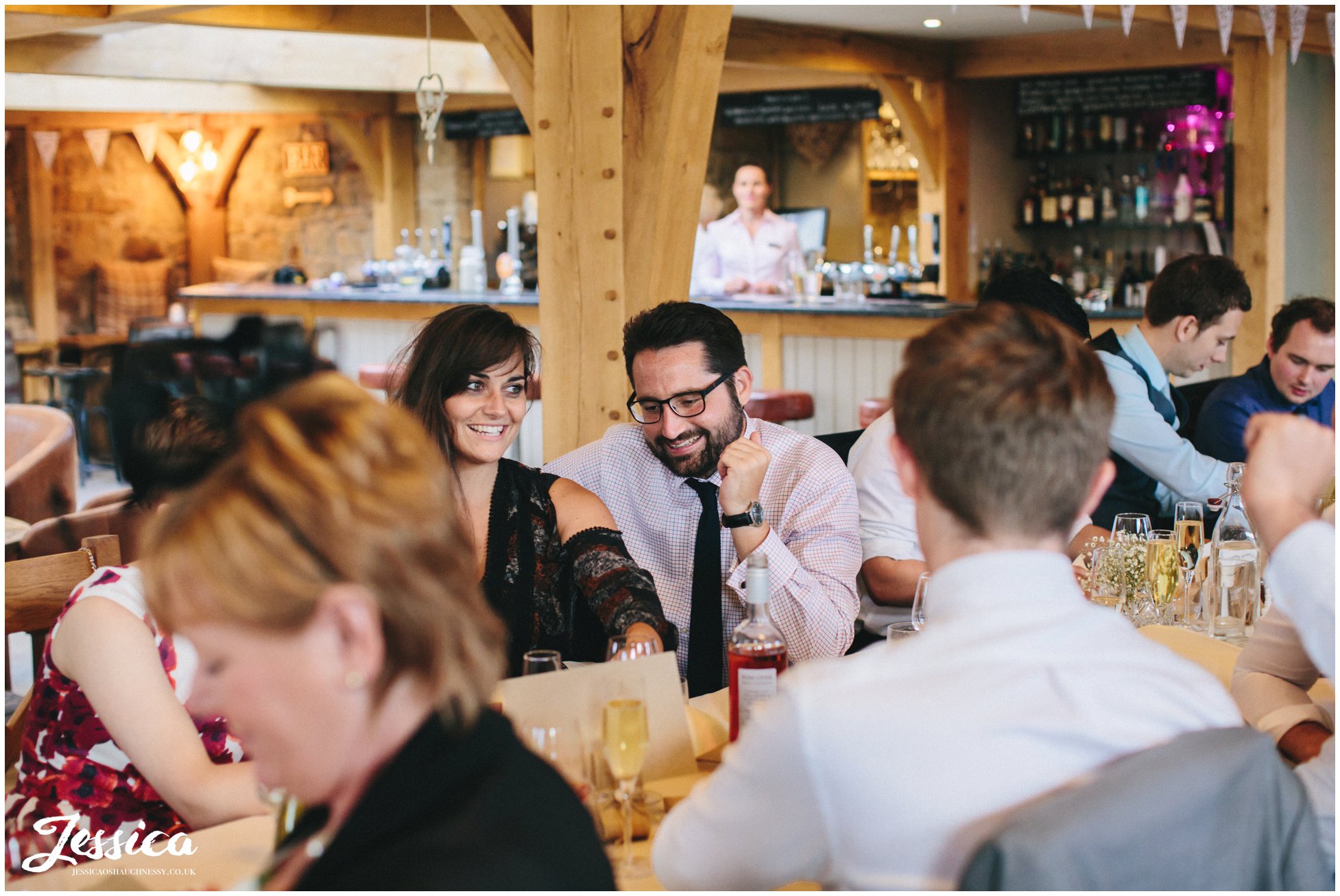 guests at a tower hill barns wedding, laugh during the speeches