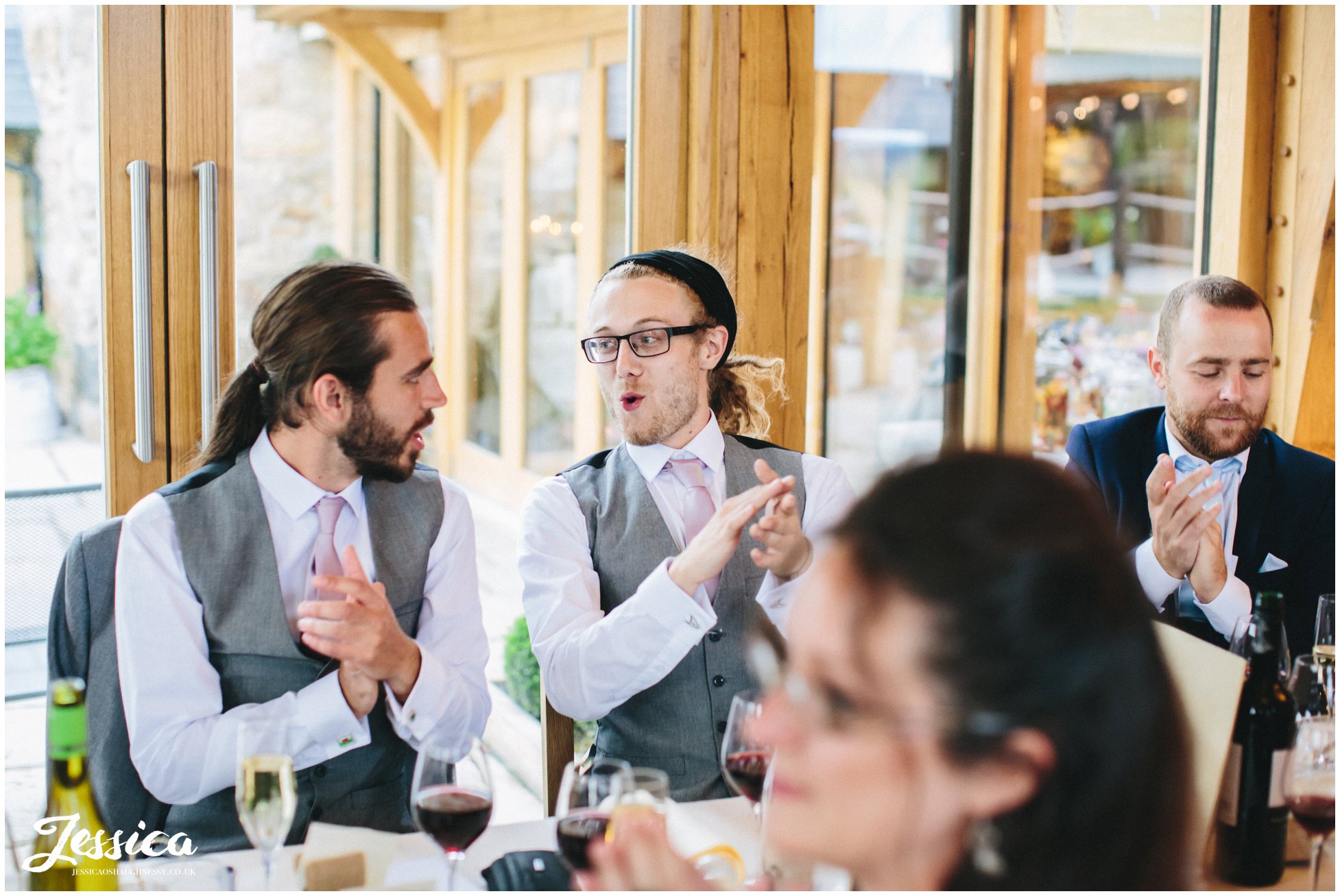 groomsmen clapping after bridesmaids sing