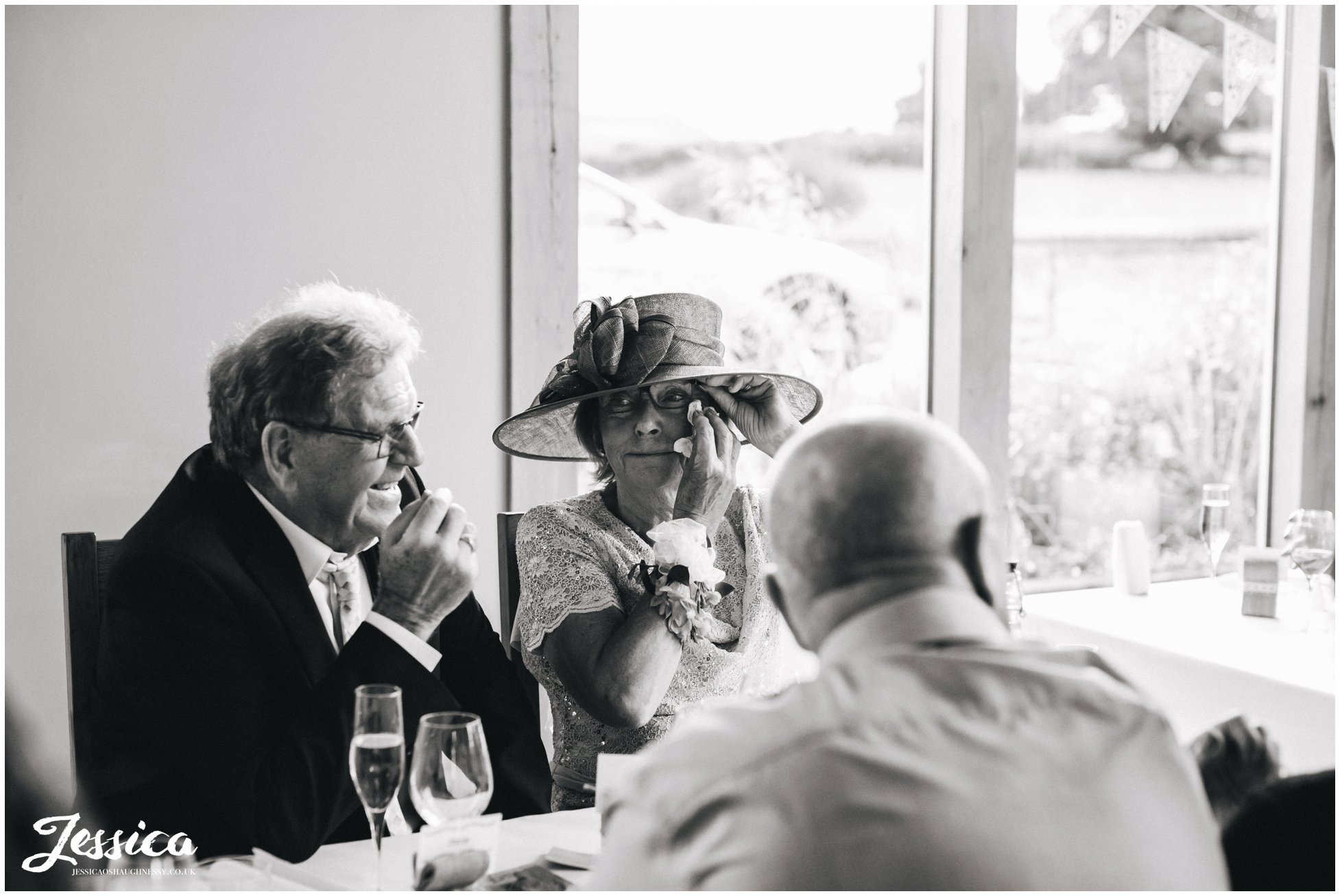 guest wipes away tears at tower hill barns during the speeches