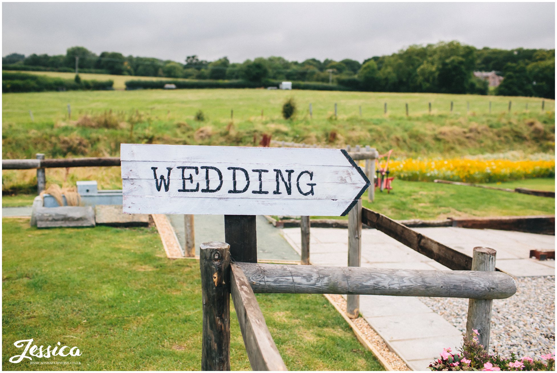 sign saying wedding points guests in the right direction