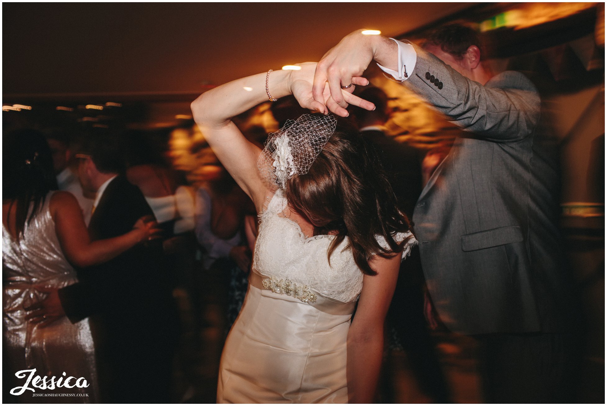 groom spins bride round on the dancefloor