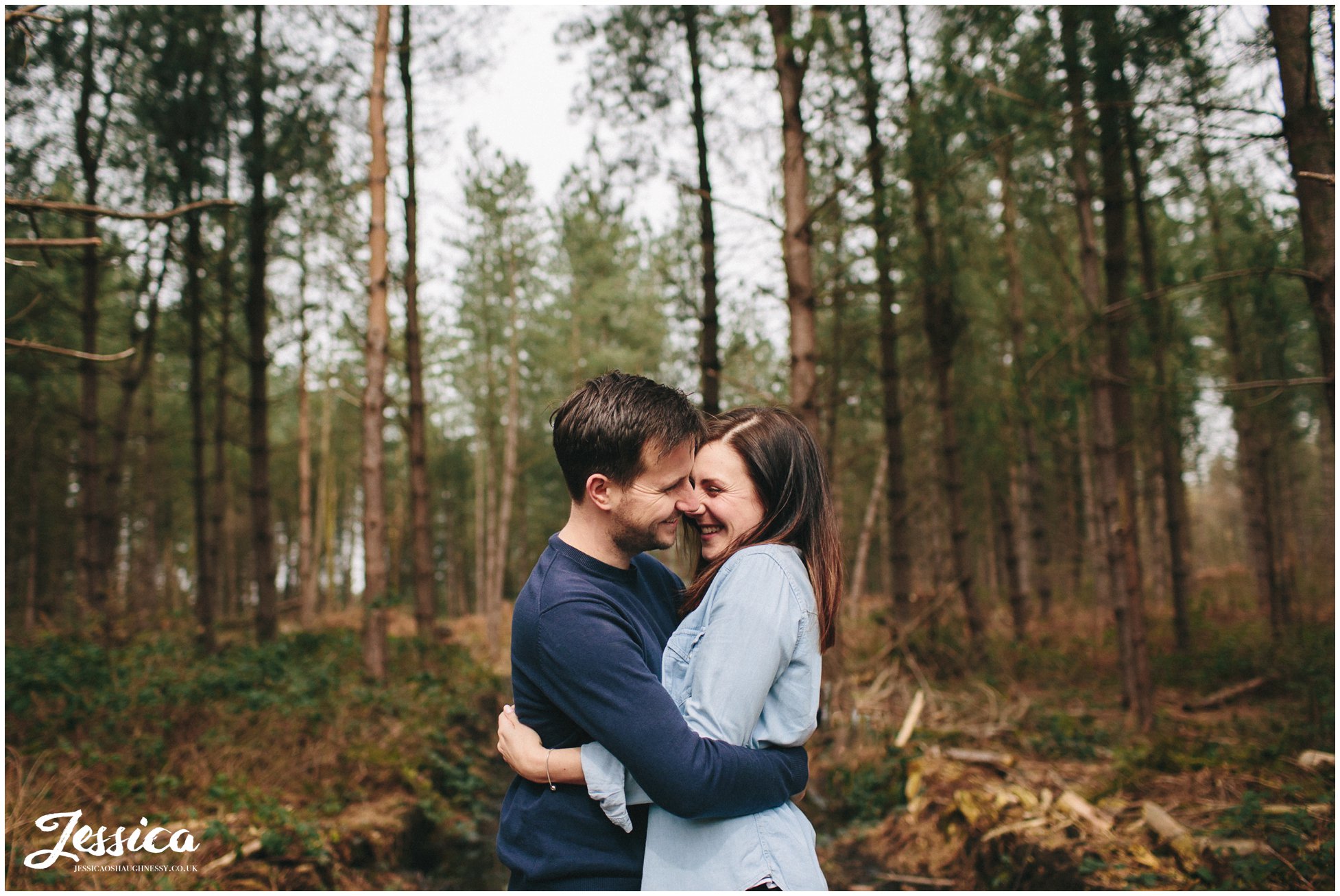 delamere forest - couple hugging and laughing during their engagement shoot