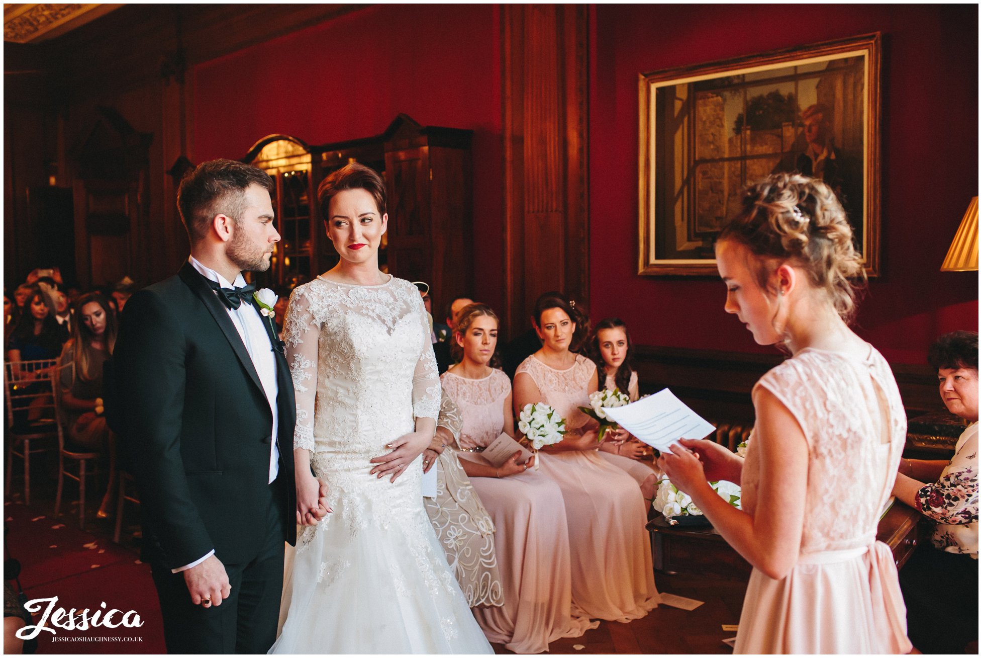 bridesmaid reads touching poem out to the bride & groom at their wirral wedding