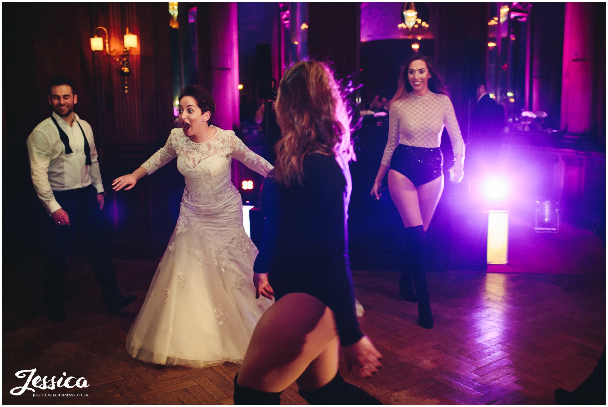 bride looks shocked as her bridesmaid suprises her