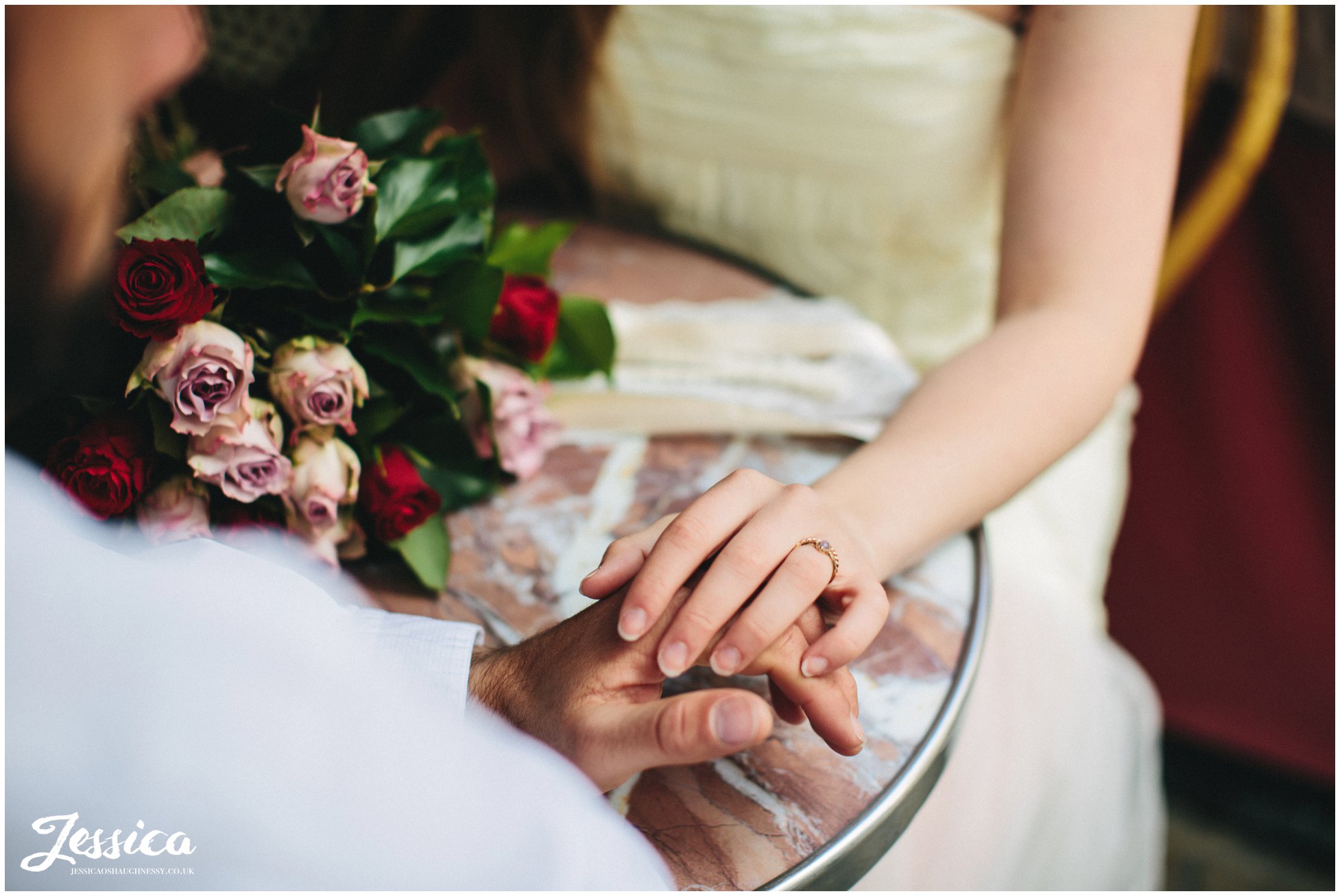 close up of bride and grooms hands on their wedding day in mont marte, paris