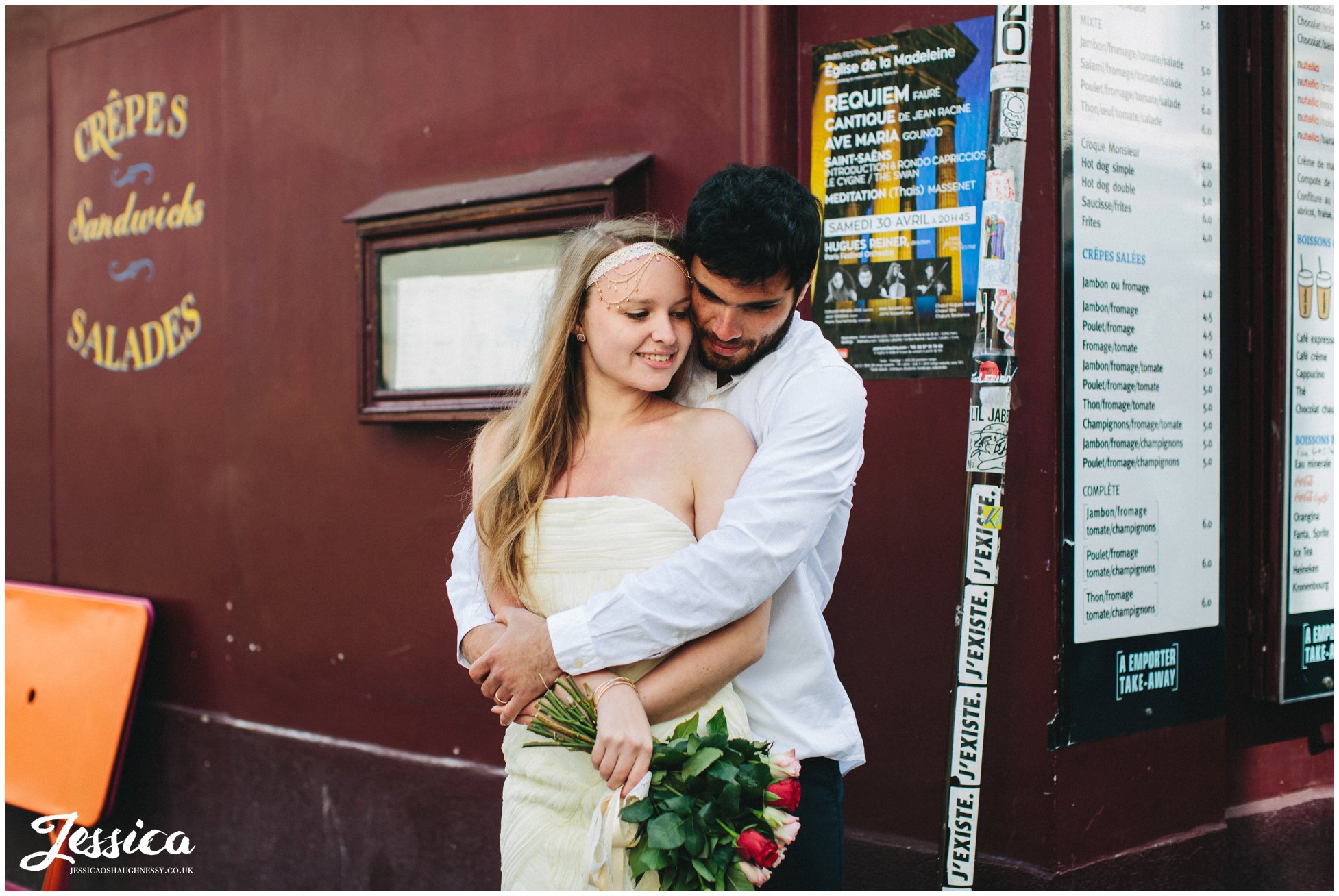 bride & groom embrace on street corner of mont marte in paris