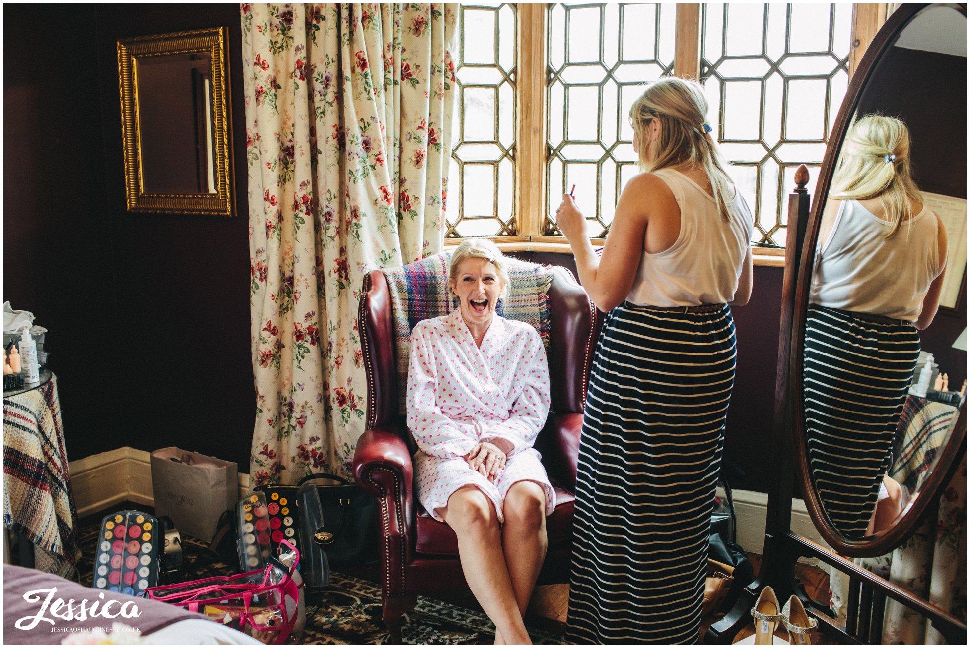 the bride getting ready in the headmasters house at her cholmondeley arms wedding cheshire