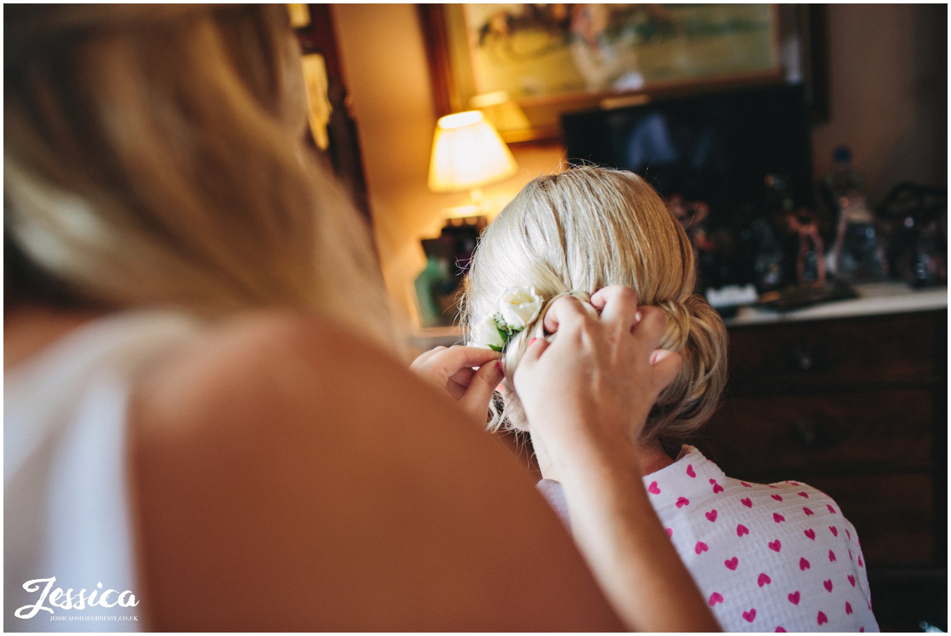 the bride getting her hair done on her wedding day