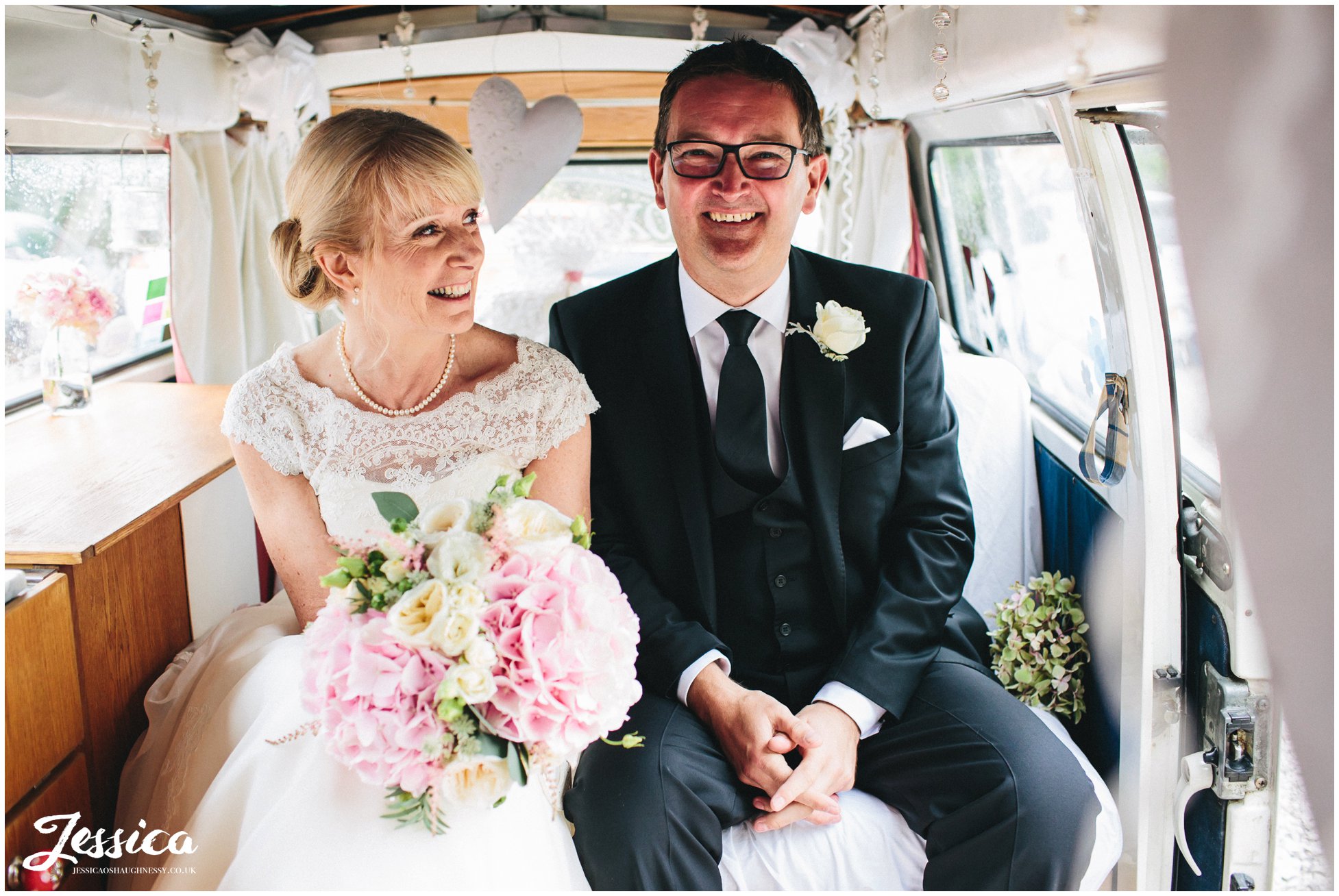 newly wed's sat in vintage vw campervan after their wedding in chester