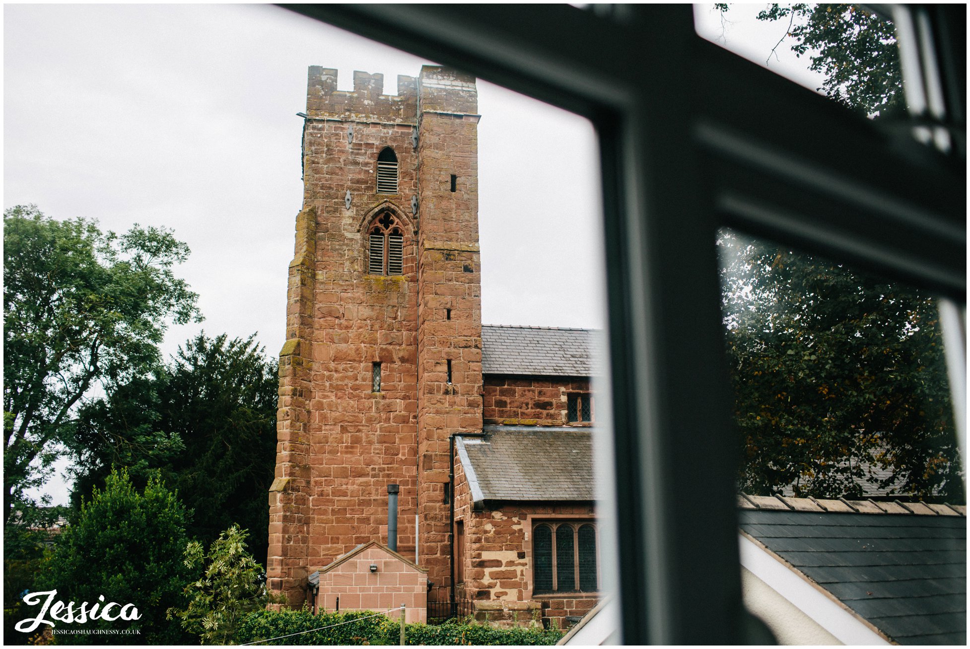 view of st chad's church in farndon taken from the bride's bedroom