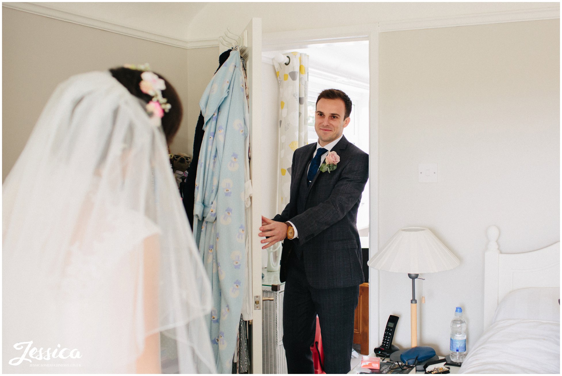 bride's brother see's his sister in her dress for the first time at her chester wedding