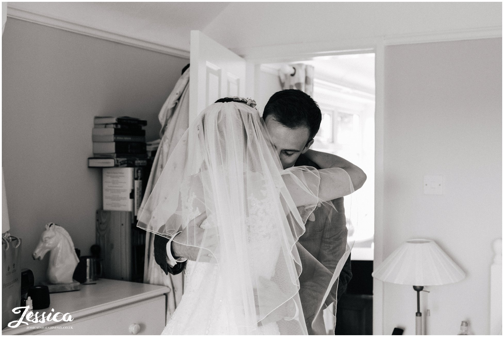 brother & sister embrace on her wedding day in chester