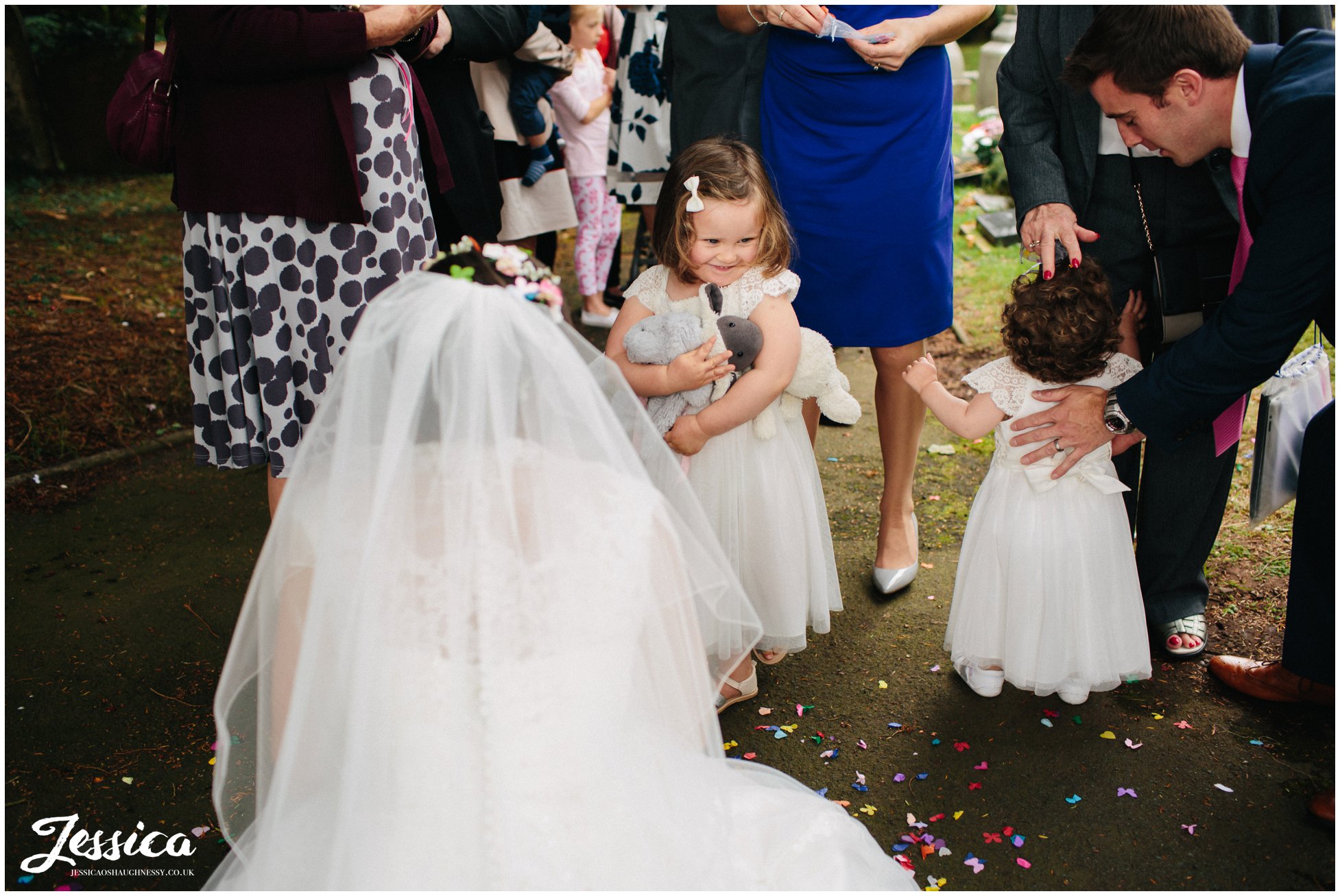 bride talking to her flower girls after the wedding ceremony