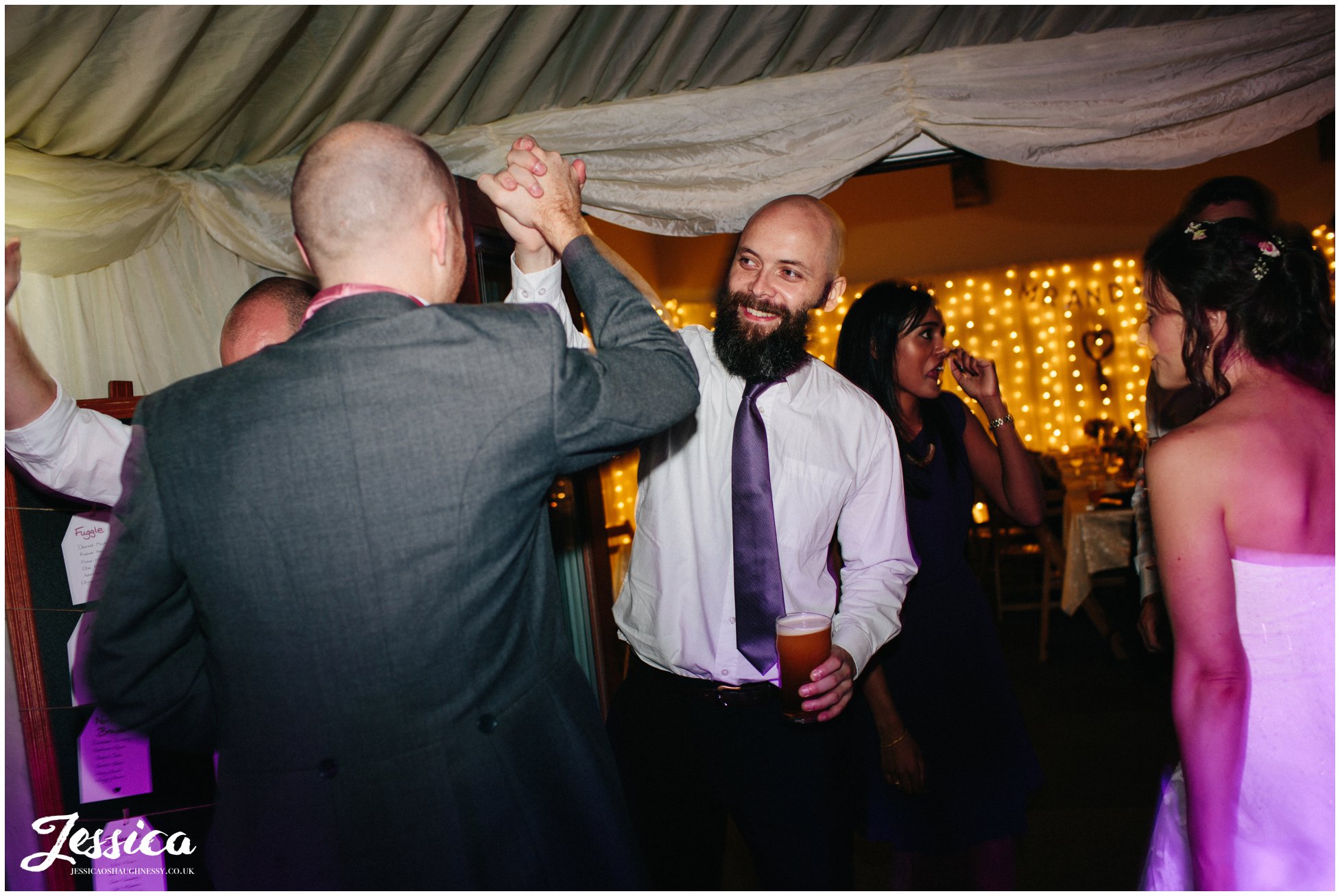 guests hi-5 whilst dancing at a wedding in cheshire